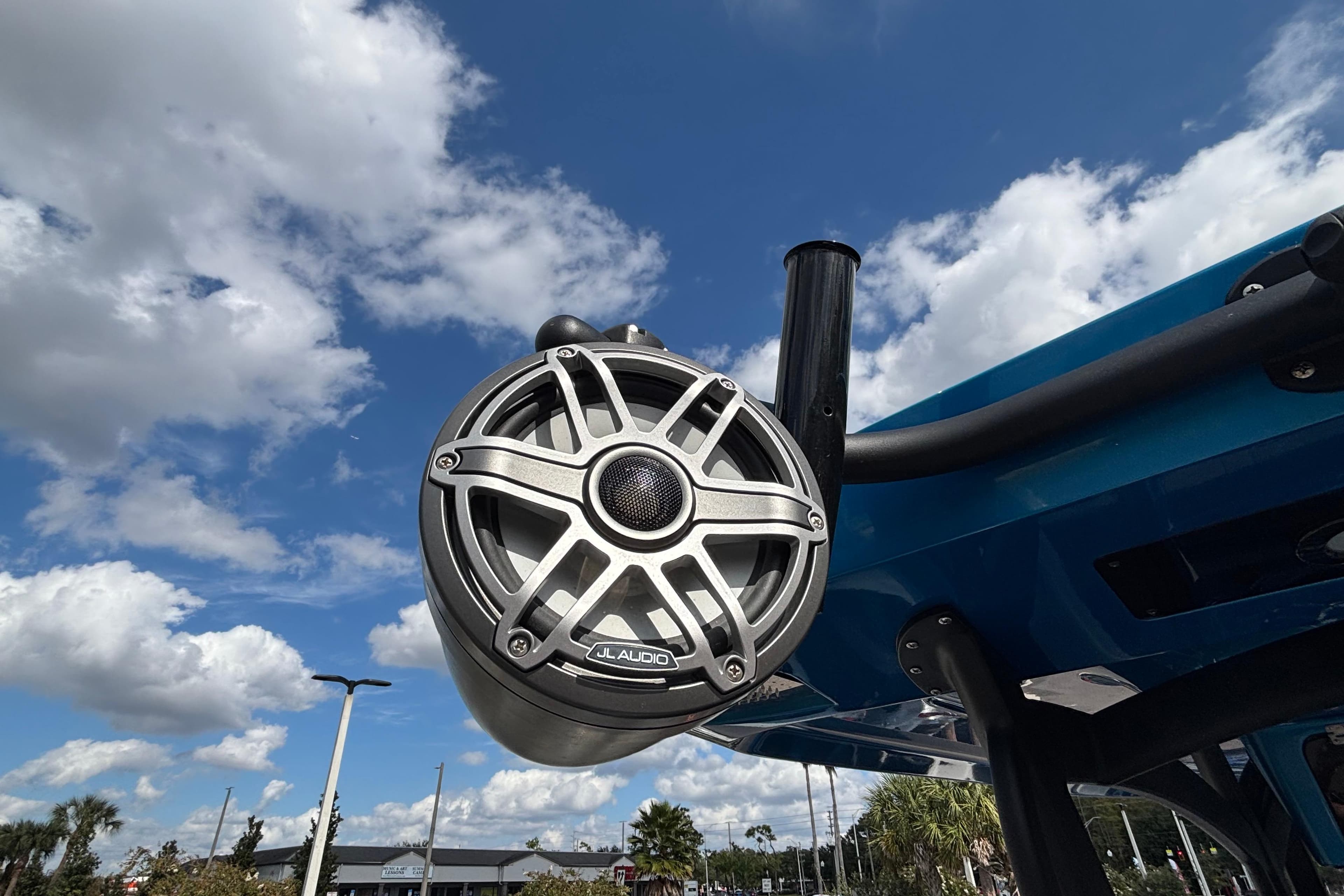Outdoor JL Audio speaker on a 2024 GSX 36 boat under a blue sky.
