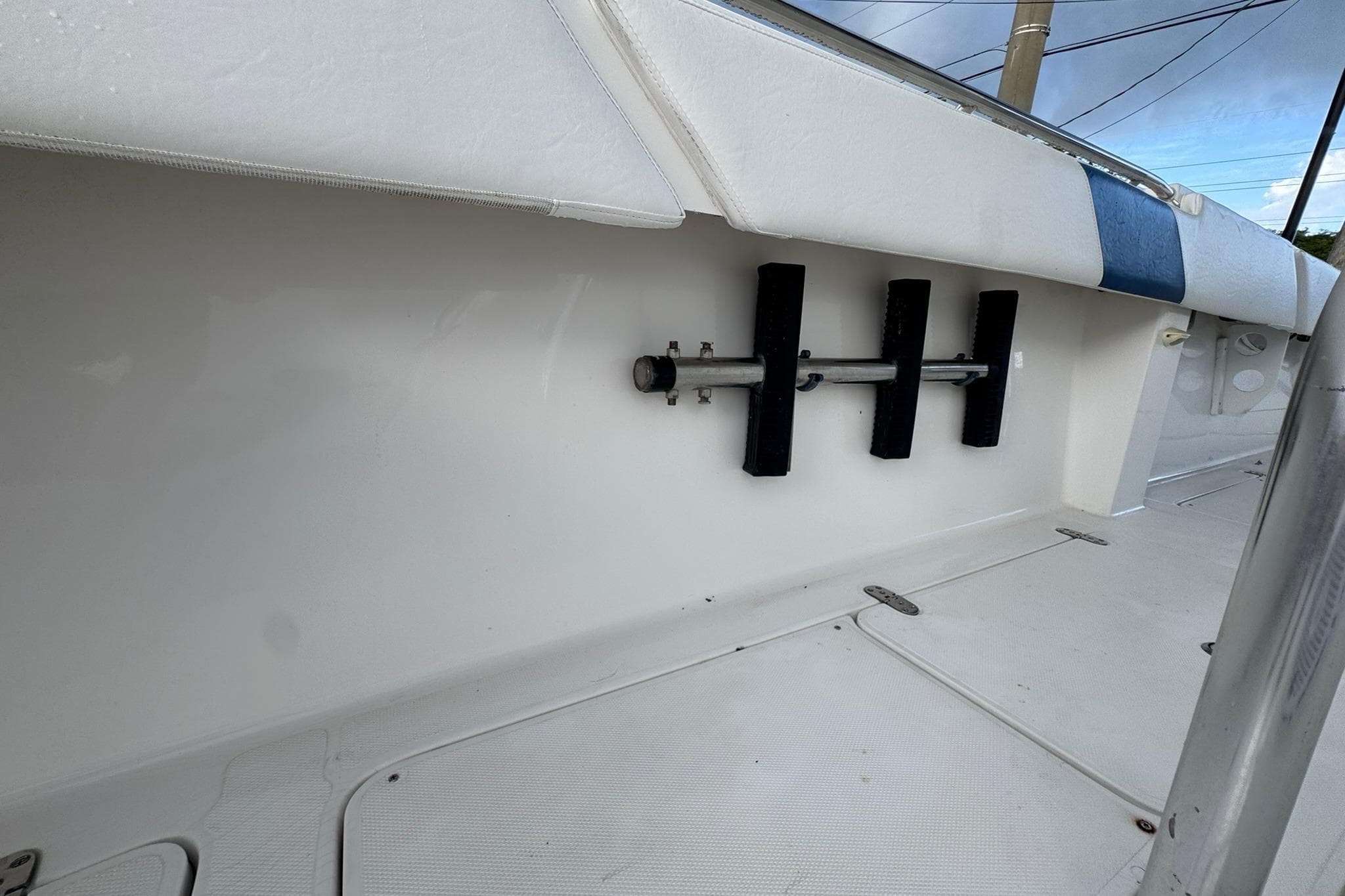 2004 Fountain 34 CC boat interior with rod holders and cushioned seating.