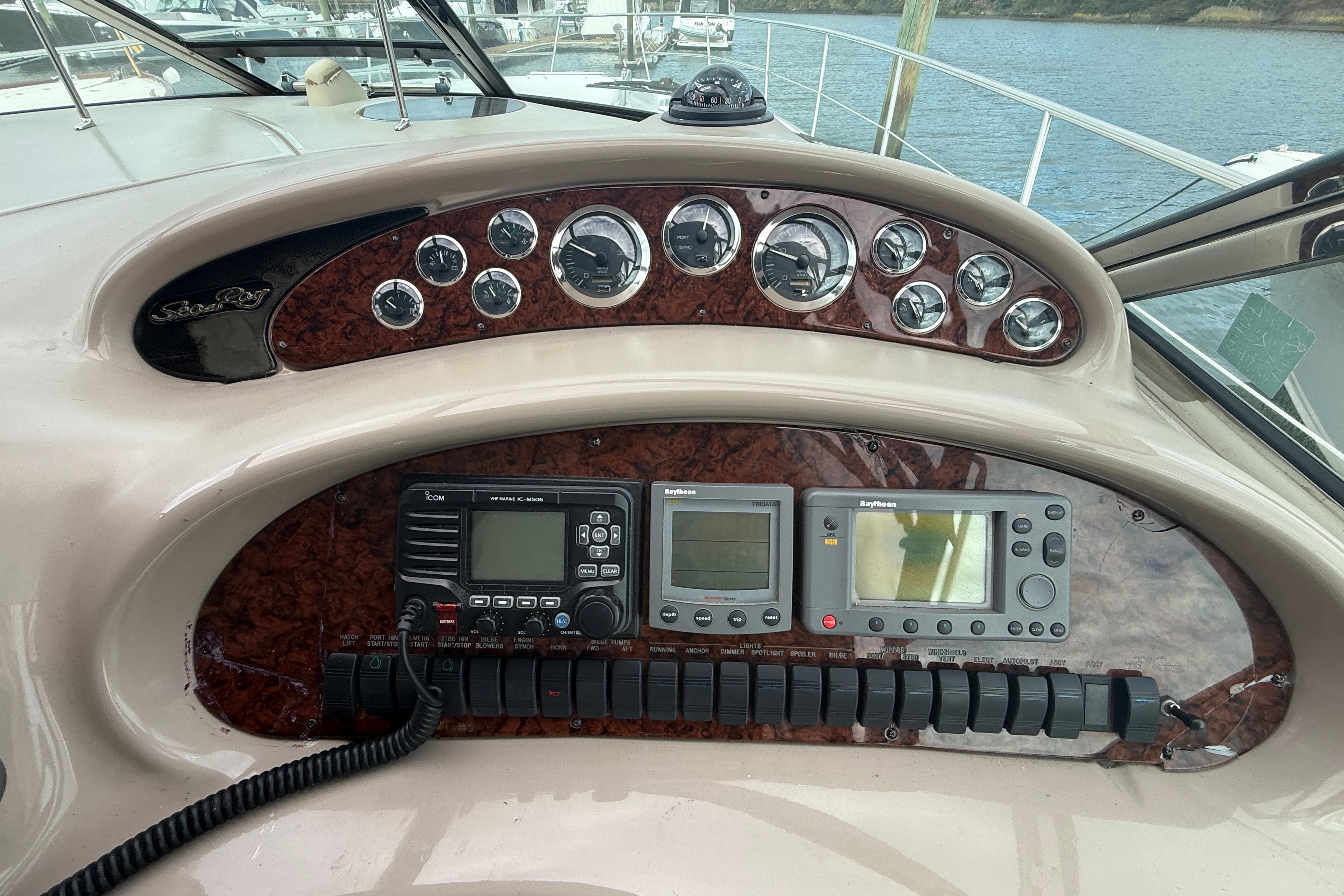 Control panel of a 2001 Sea Ray 410 Sundancer yacht with navigation instruments.