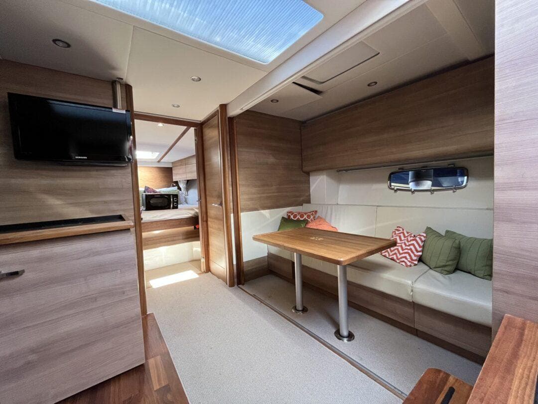 Luxurious 2012 Sealine SC 47 yacht interior with cozy seating and modern amenities.