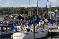 1985 Tartan 28 Piper sailboat docked in a marina with scenic background.
