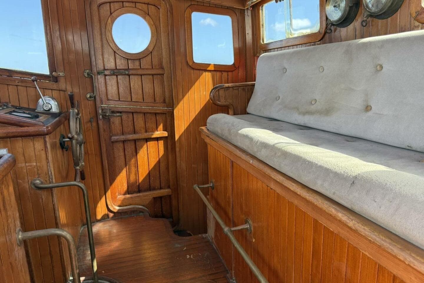 Interior of 1986 Lord Nelson 37 #49 boat with wooden paneling and cushioned seating.