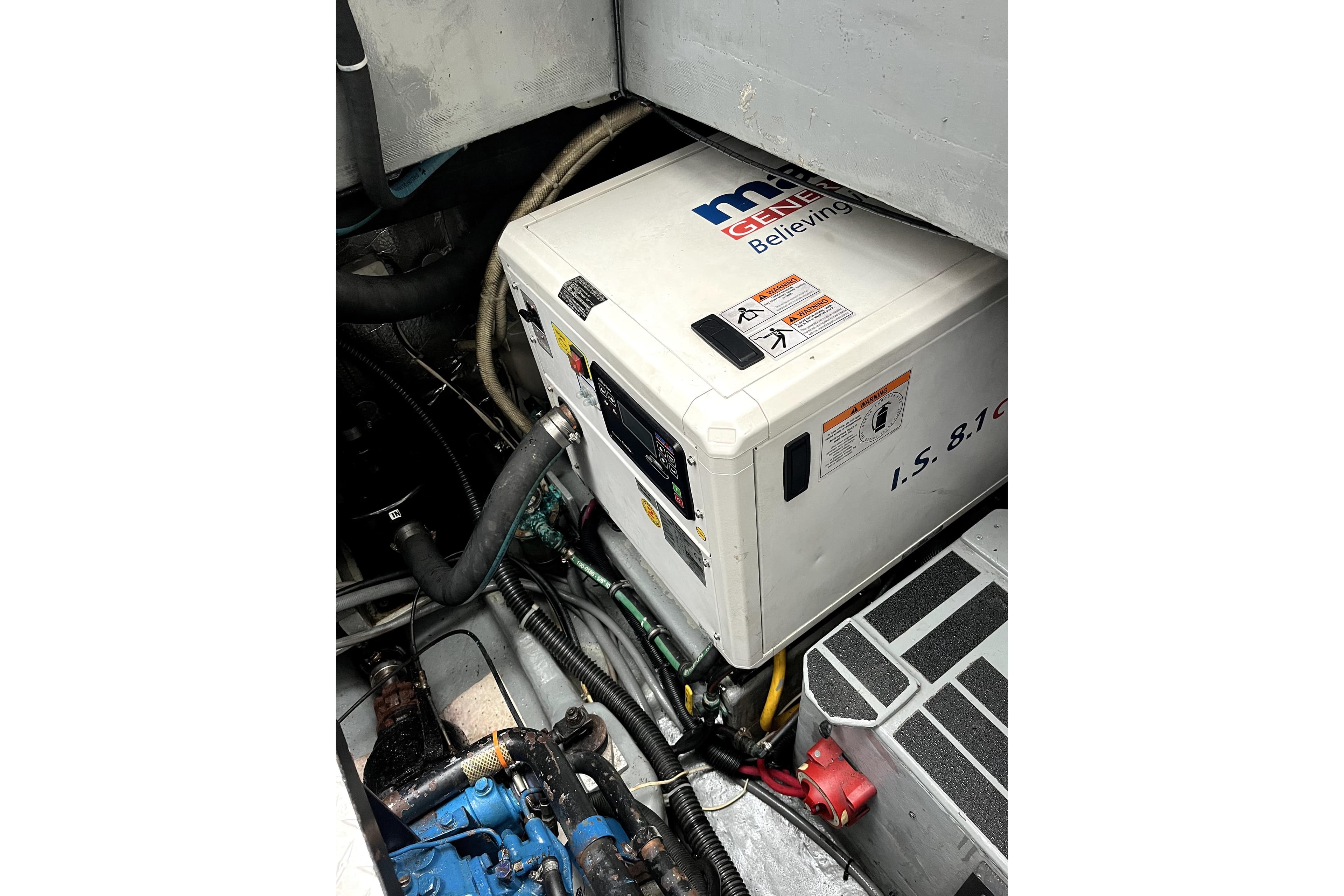 Engine room of a 1979 Amel Mango sailboat featuring a generator.