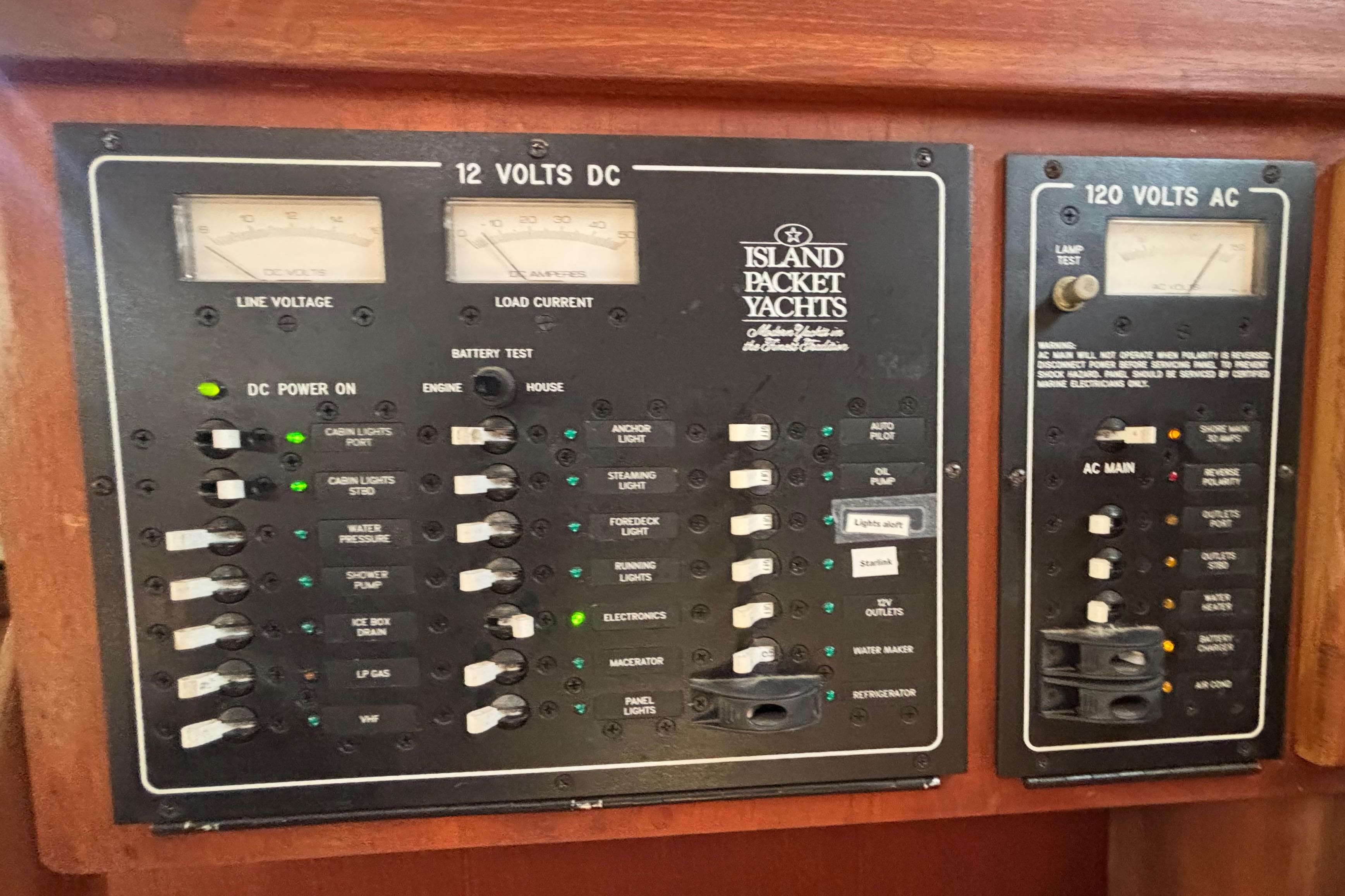 Electrical control panel of a 2002 Island Packet 380 yacht, featuring DC and AC systems.