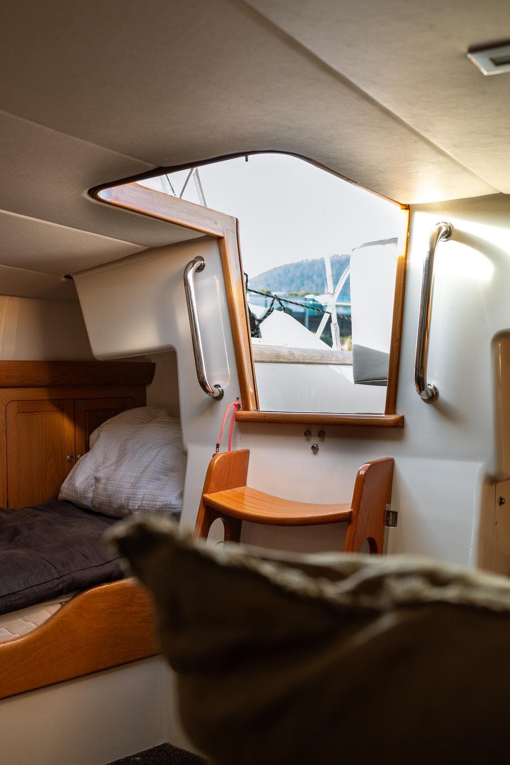 Cozy cabin interior of 1993 Dubois 78 yacht with bed and window view.