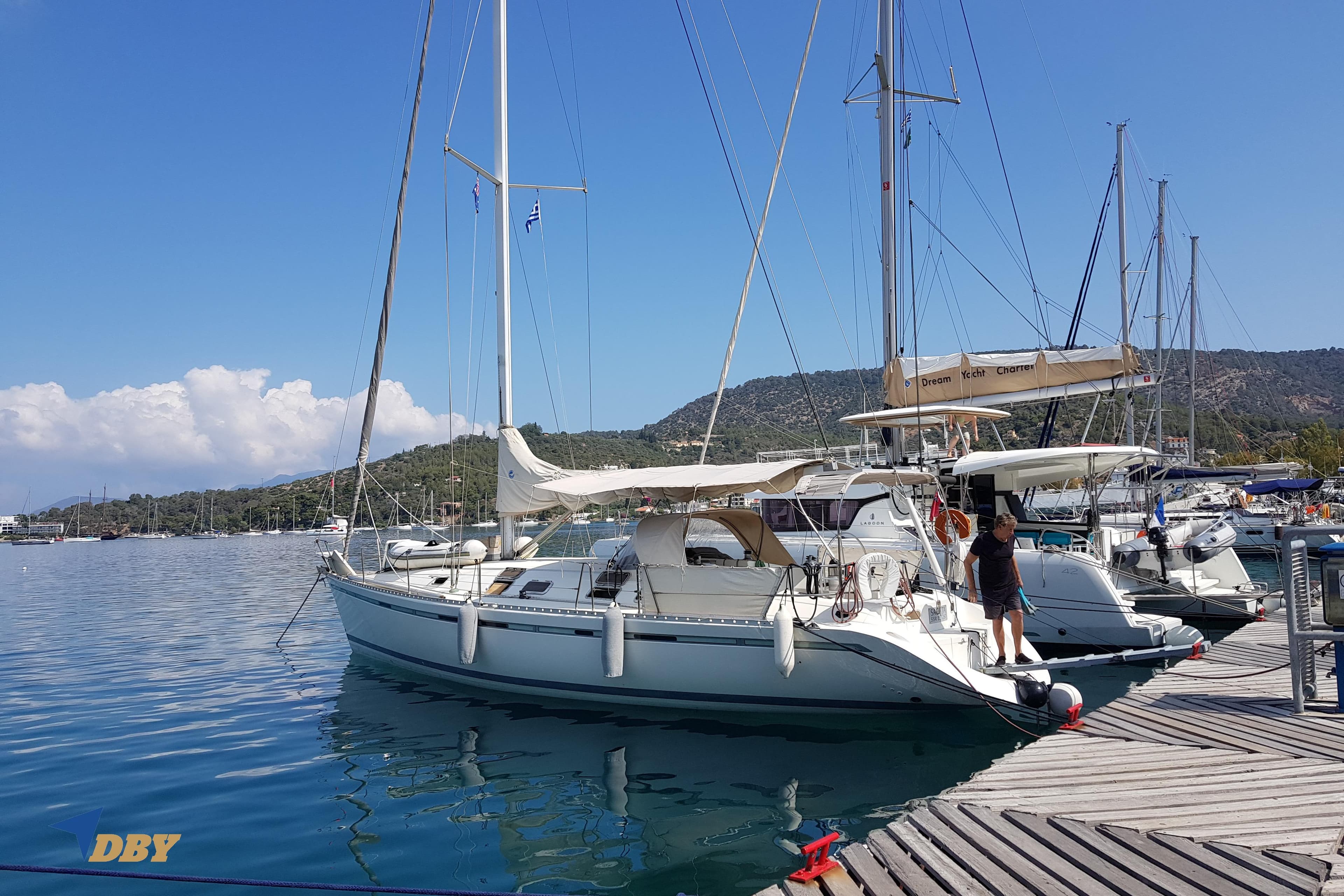 Sailboat Beneteau First 45f5, 1993 model, docked at marina with scenic backdrop.