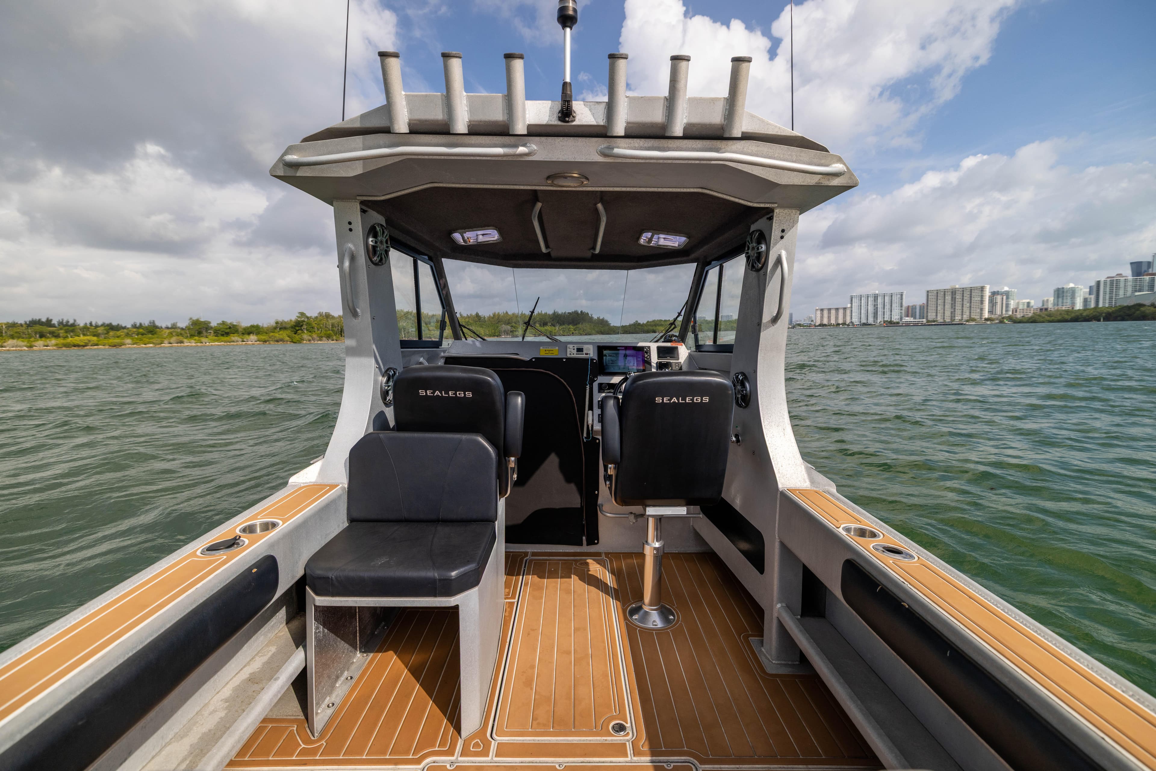 2022 Sealegs 8.5M boat interior with seating, on a sunny day, near city skyline.