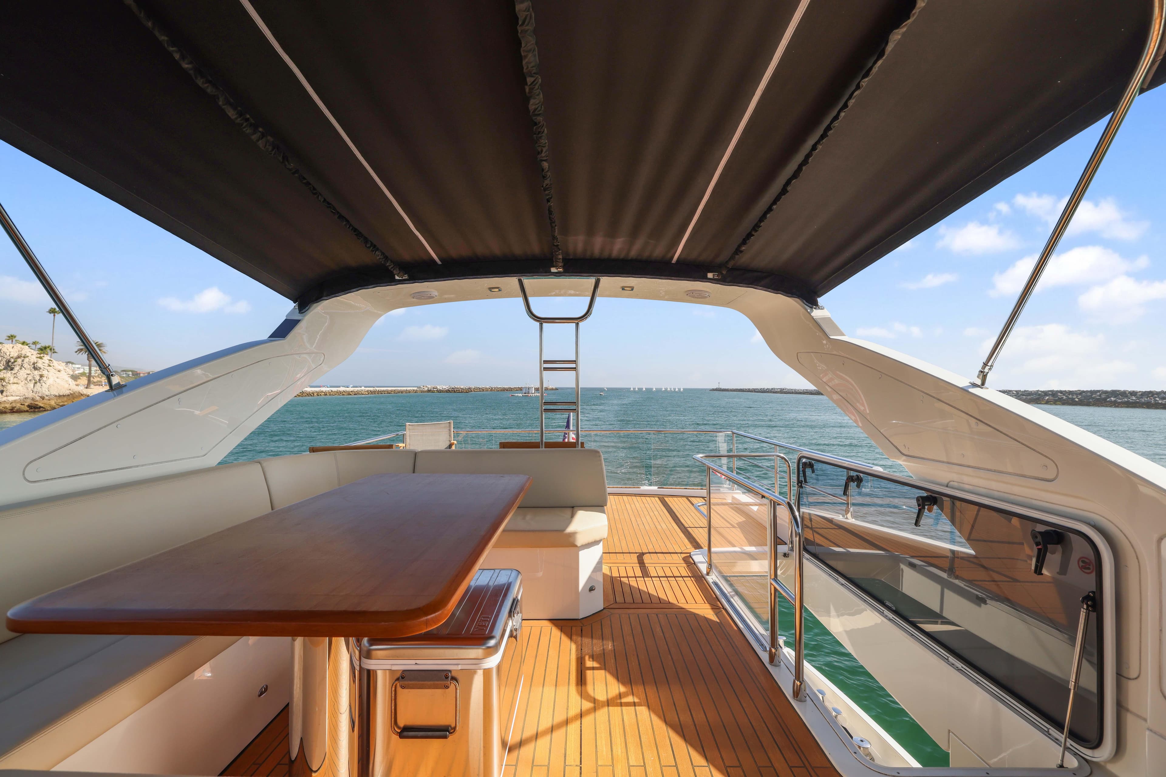 Luxurious Absolute Fly Co Ownership yacht deck with seating, table, and ocean view, 2015 model.