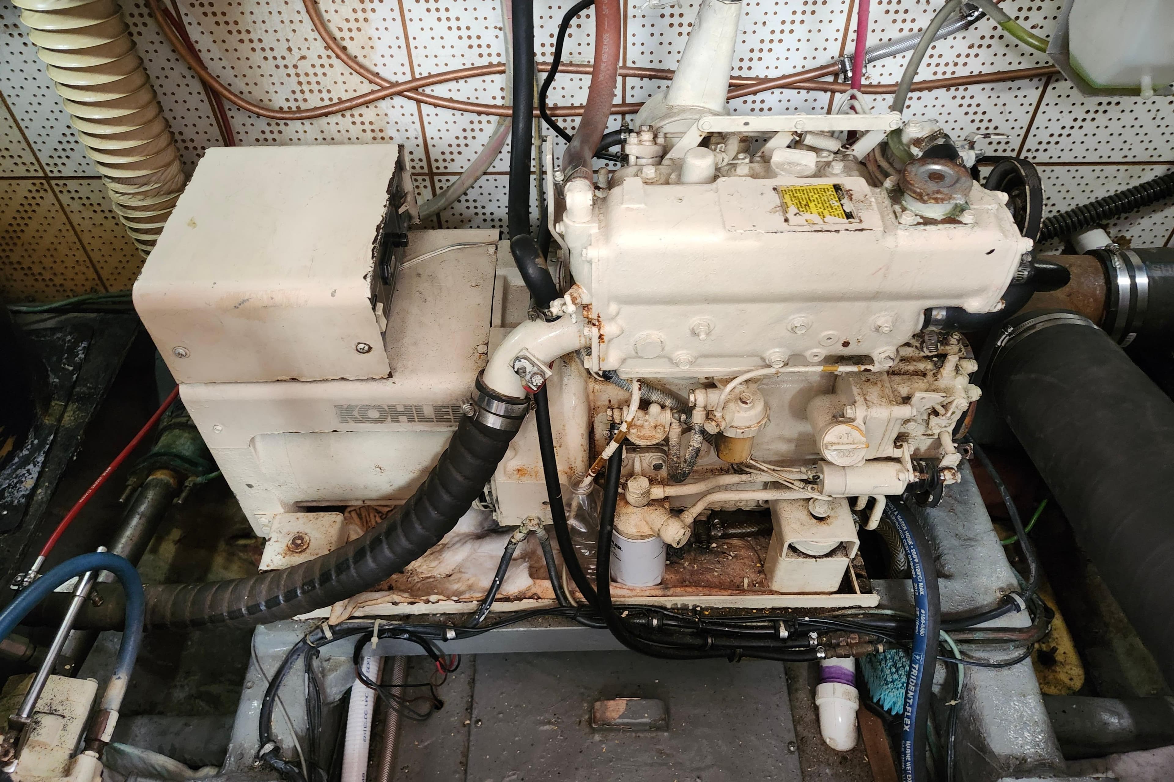 Engine room of a 1988 Marine Trader 43 with Kohler generator.