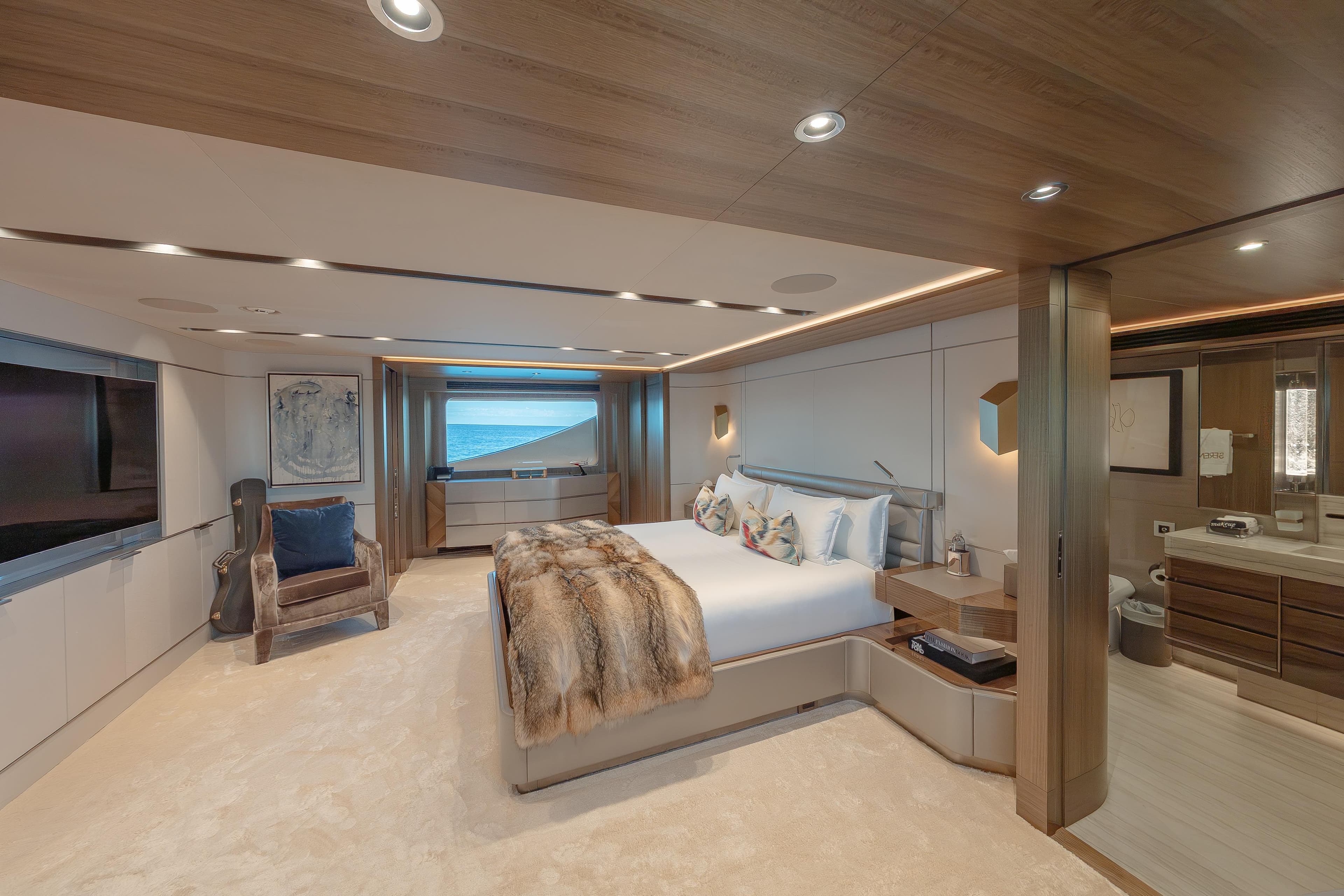 Luxurious bedroom interior on 2018 Westport Raised Pilothouse yacht, featuring elegant decor and ocean view.