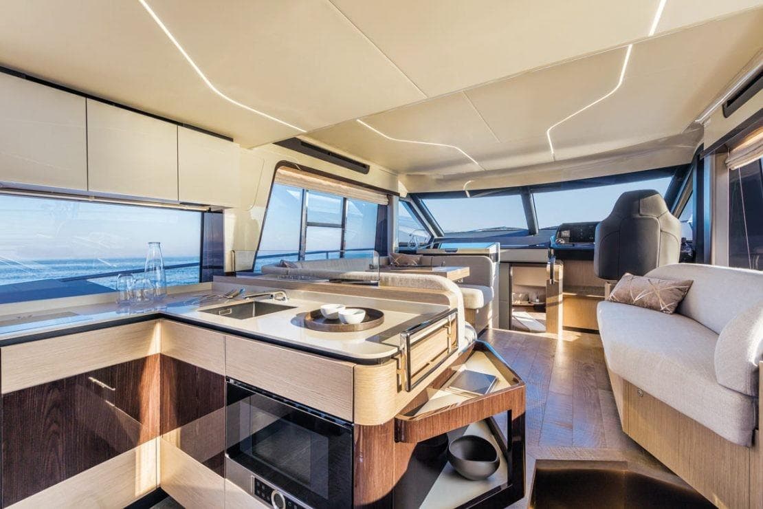 Luxurious interior of 2025 Absolute 47 Fly yacht with modern kitchen and seating area.