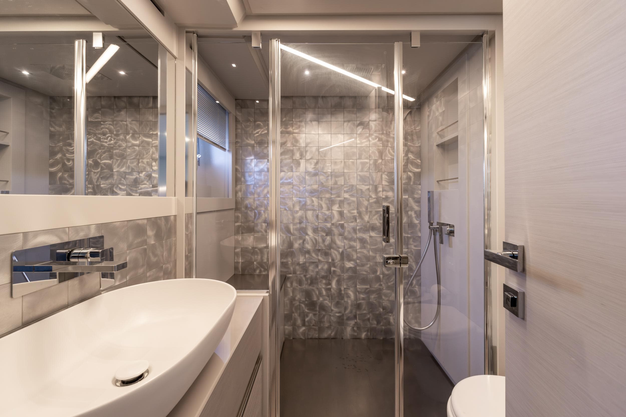 Luxurious bathroom interior of 2024 Pershing 7X yacht with modern fixtures and elegant design.