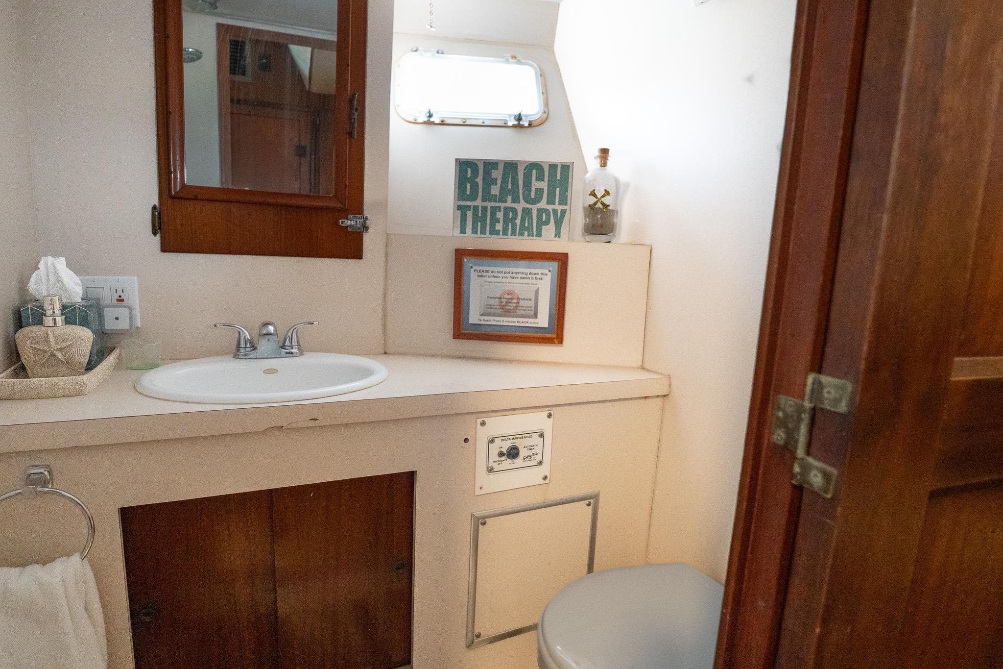 Bathroom interior of 1975 Hatteras 58 YF yacht with sink and decor.