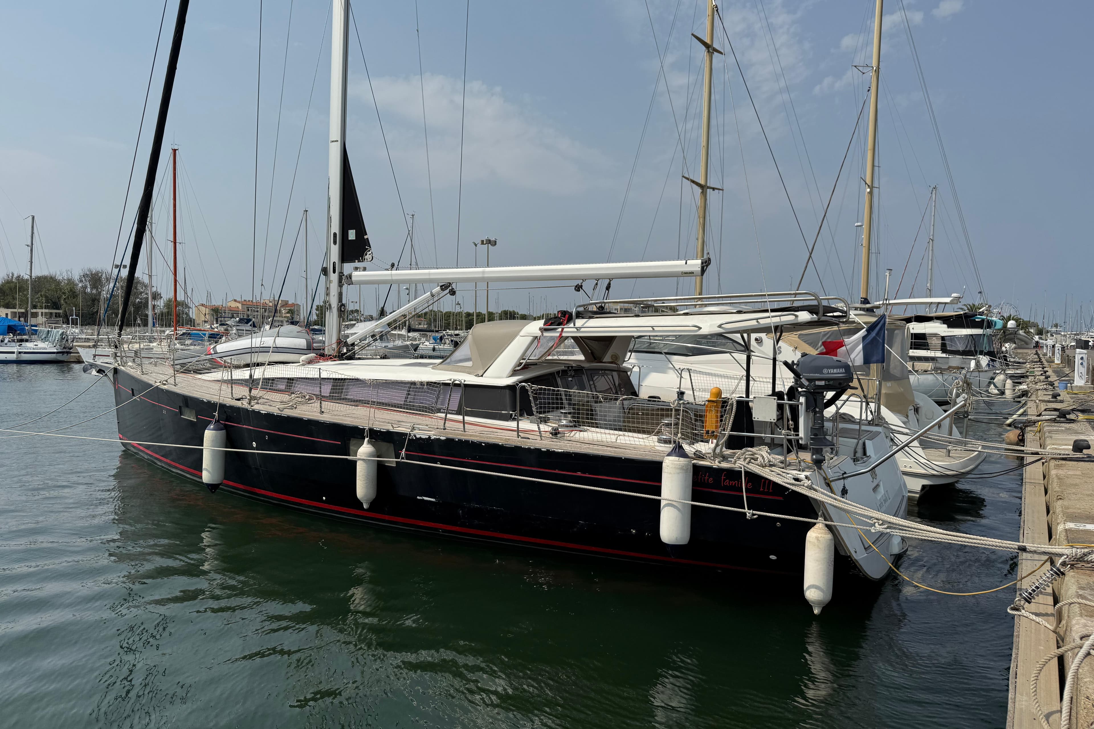 2018 Beneteau Sense 51 yacht docked at marina, showcasing sleek design and modern features.