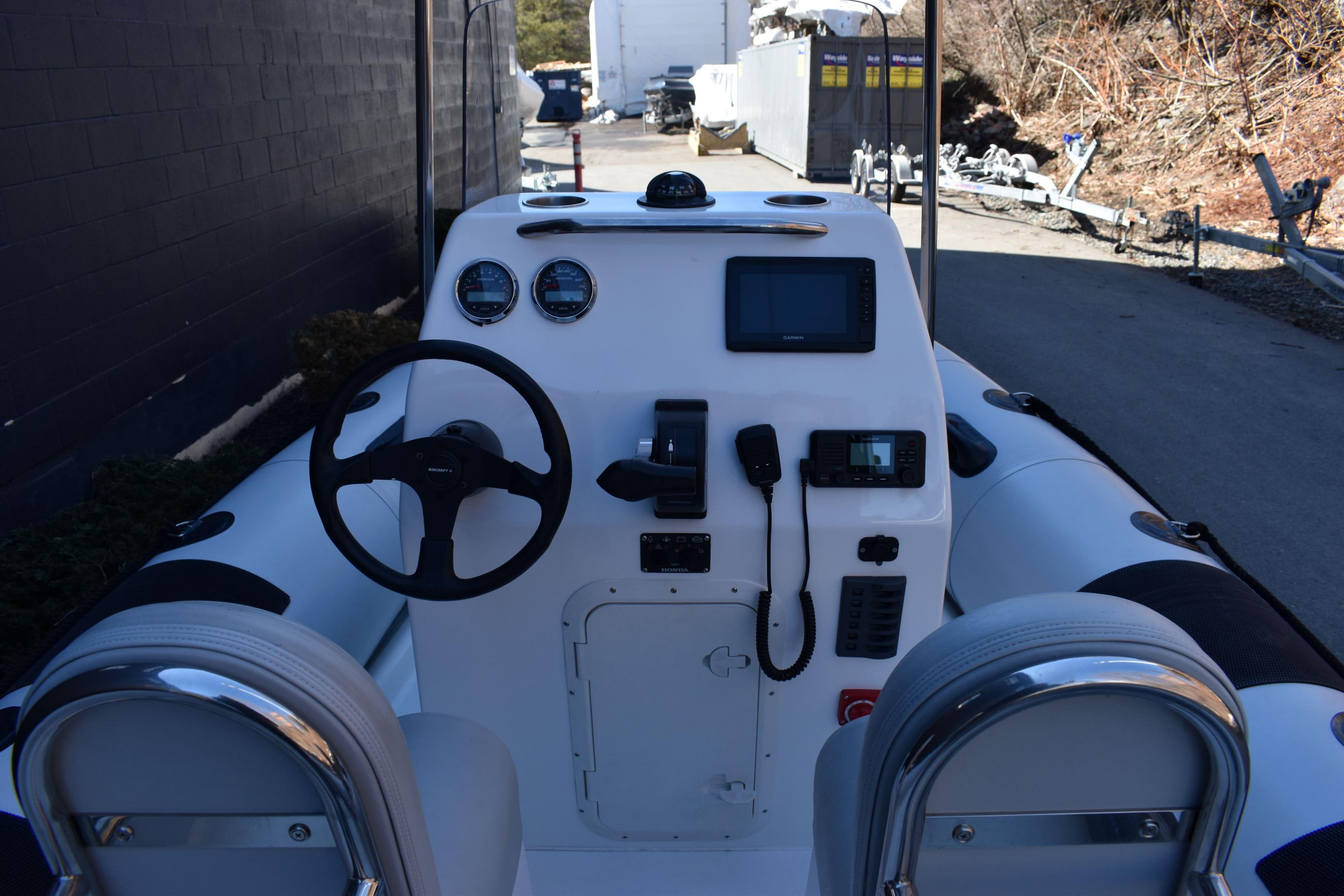 2020 Ribcraft 5.85 boat dashboard with steering wheel and navigation instruments.