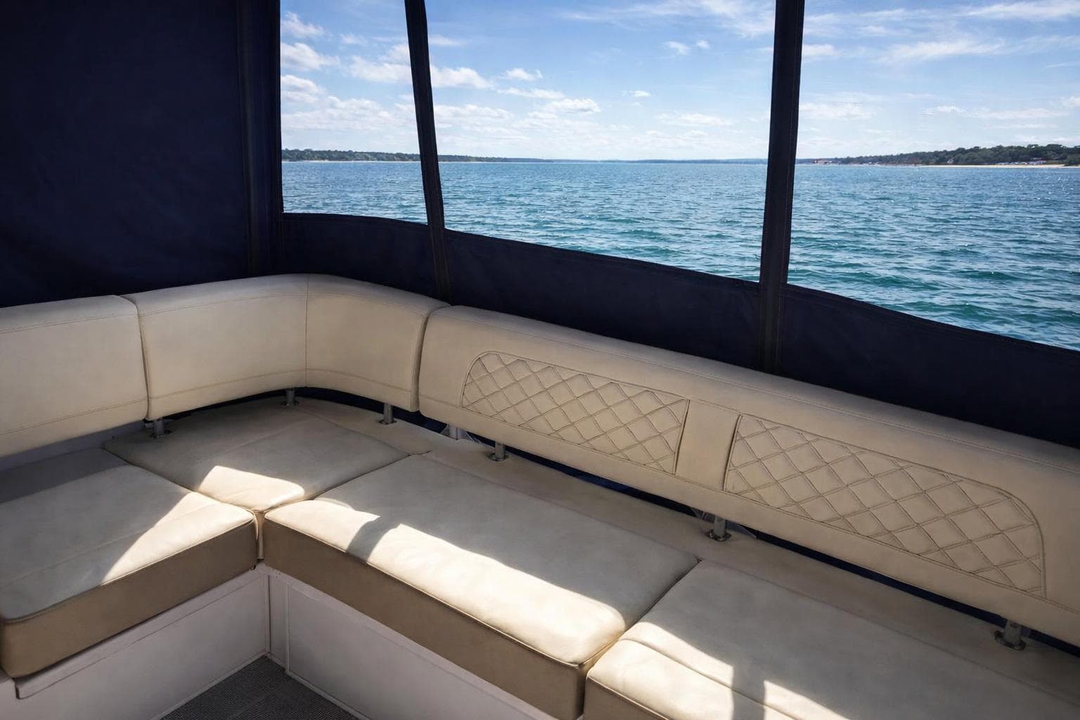 Luxurious seating on 2019 Regal 42 Grande Coupe yacht with ocean view.