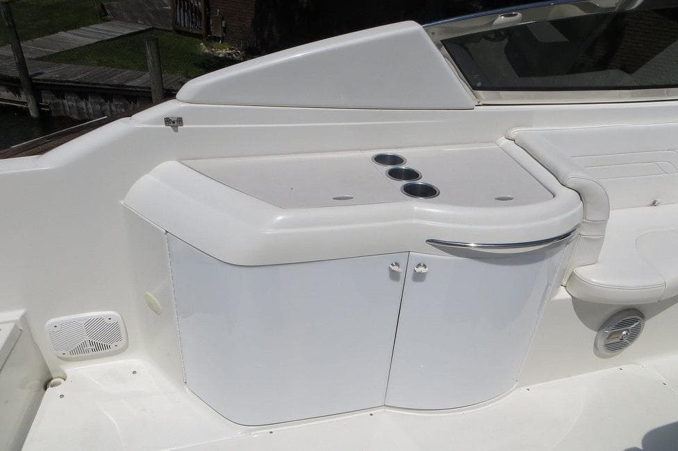 2003 Formula 330 Sun Sport boat interior with cup holders and storage cabinet.