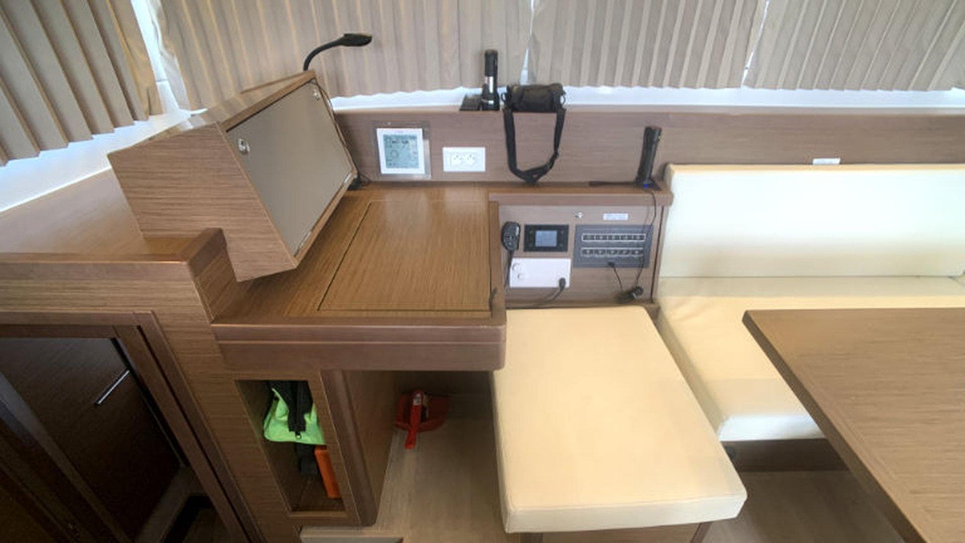 Interior of 2019 Lagoon 40 yacht with navigation station and seating area.