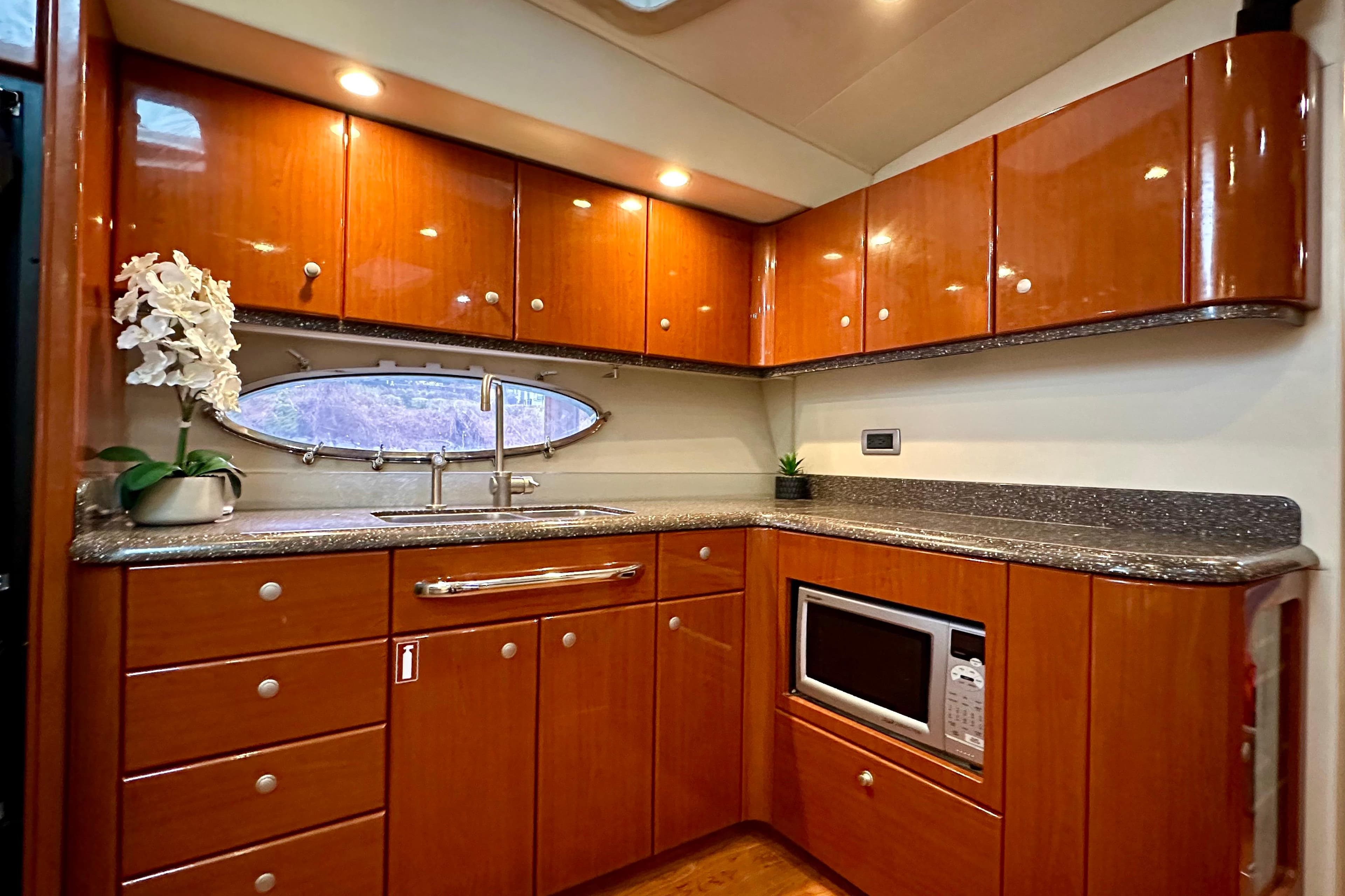 Luxurious kitchen interior of 2008 Formula 45 Yacht with wood cabinets and modern appliances.