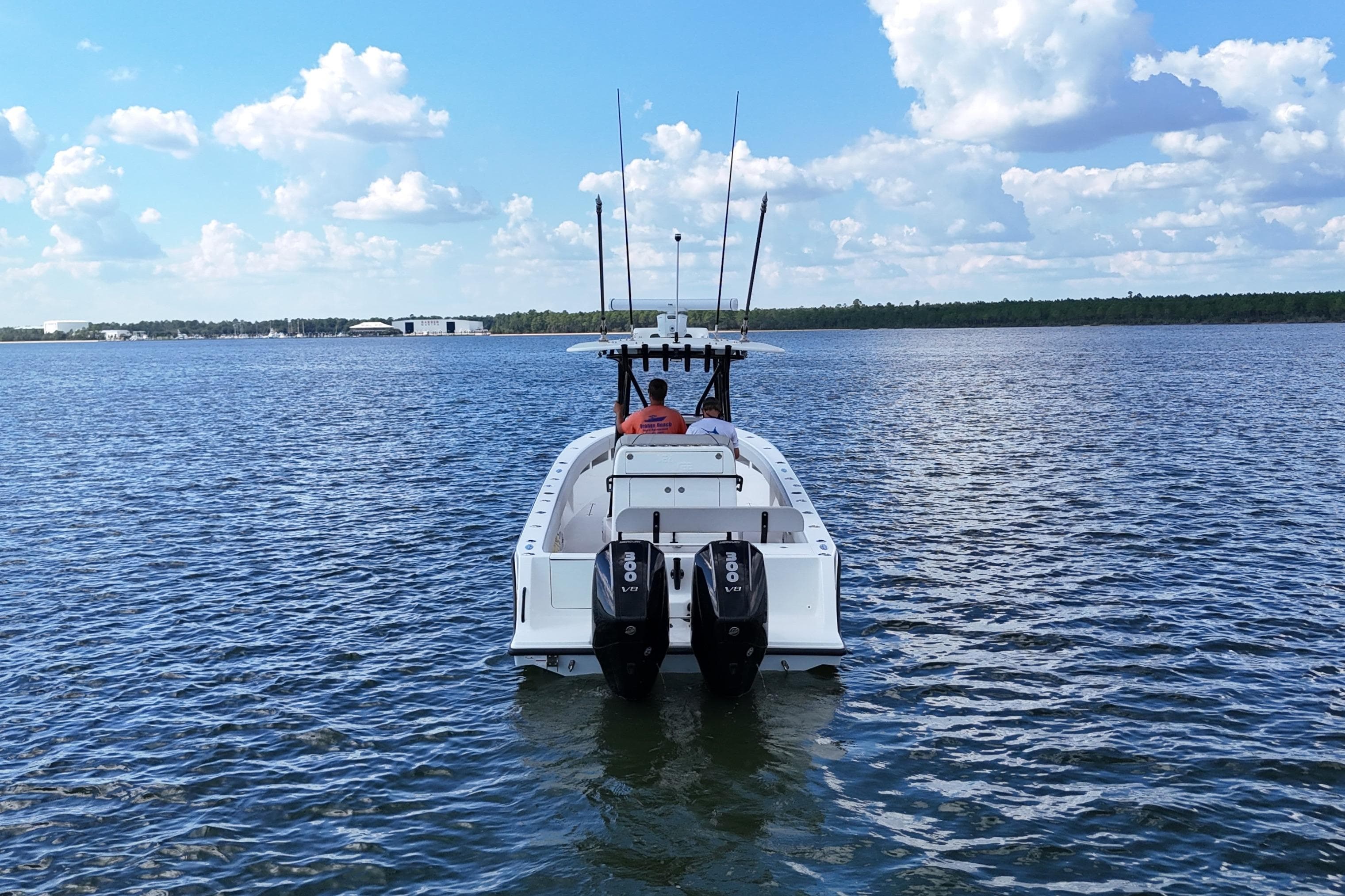 2023 SeaVee 32 boat on open water with twin engines, clear sky.