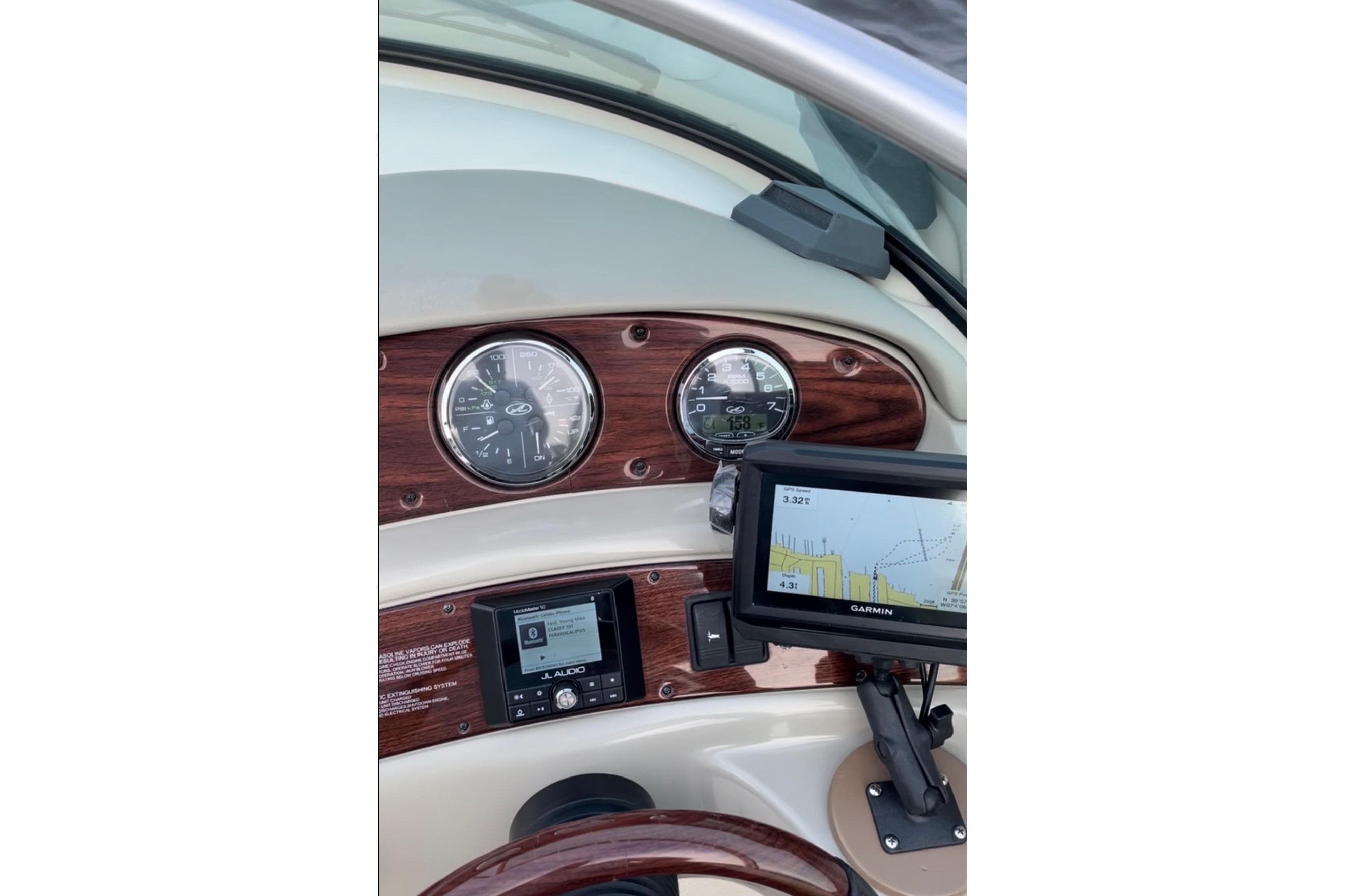 Dashboard of a 2006 Sea Ray 240 Sundeck with Garmin navigation system.