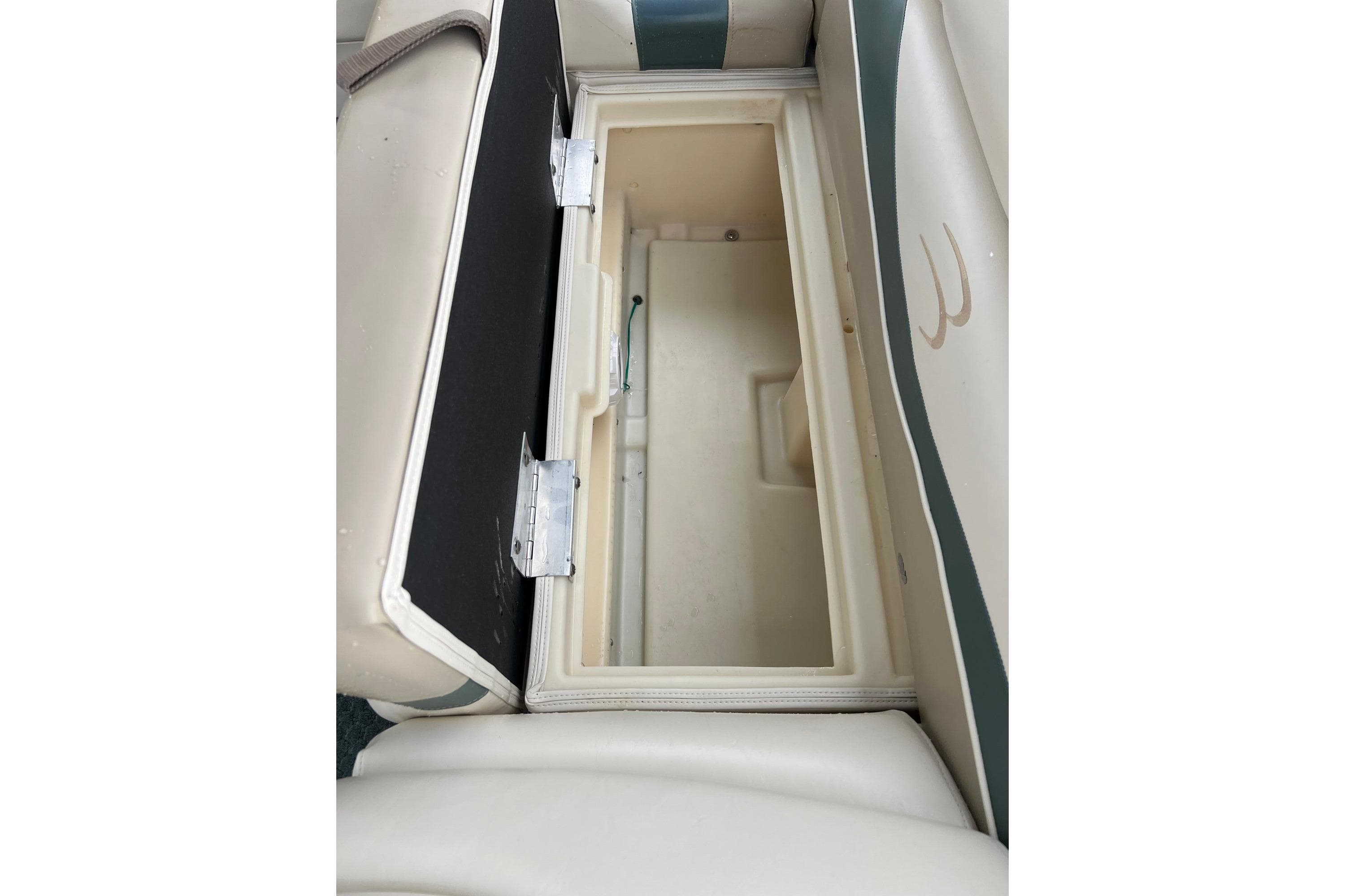 Open storage compartment on a 2006 Bennington 2575 FS boat seat.