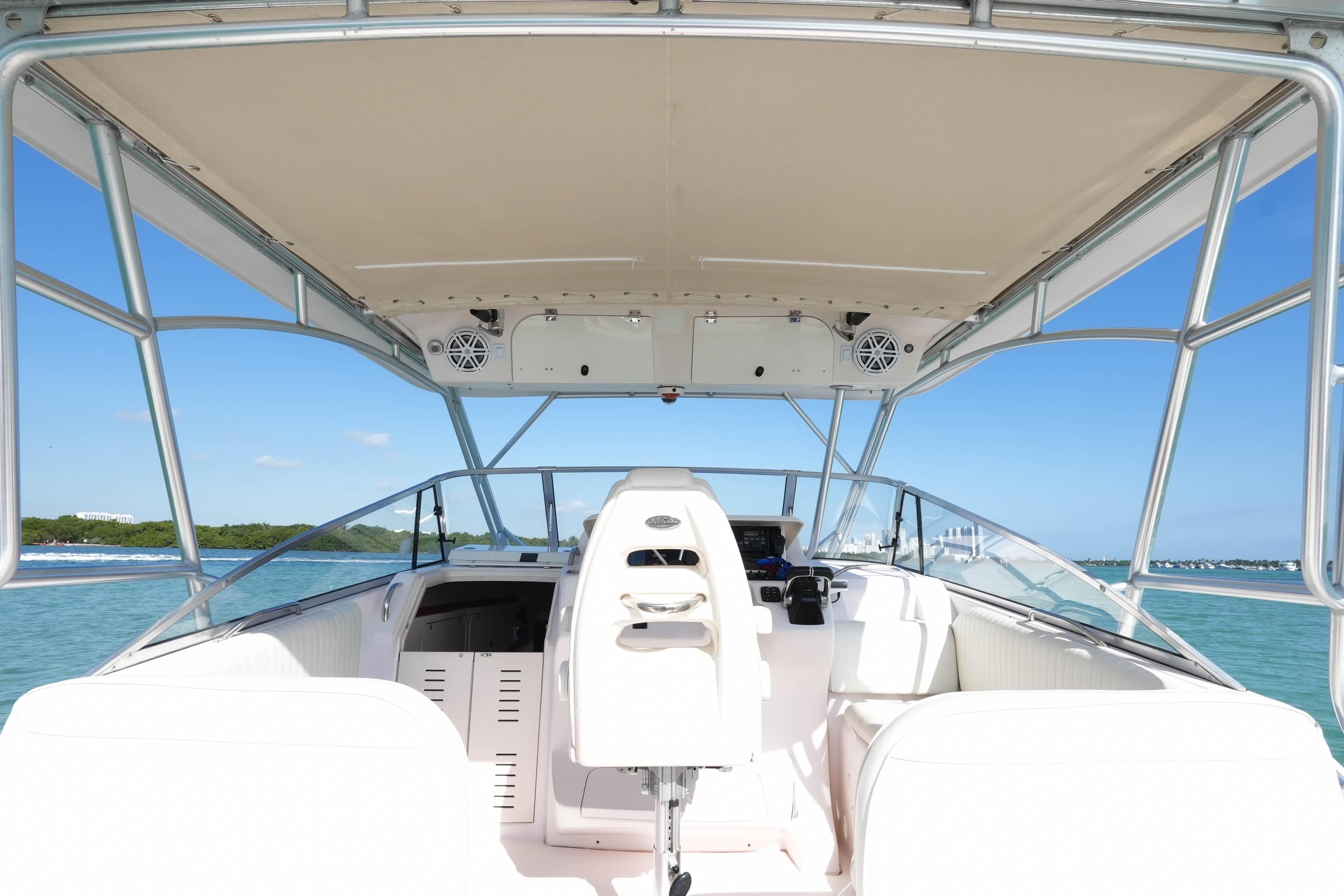 2003 Grady-White Express 330 boat interior with helm, ocean view, and clear sky.