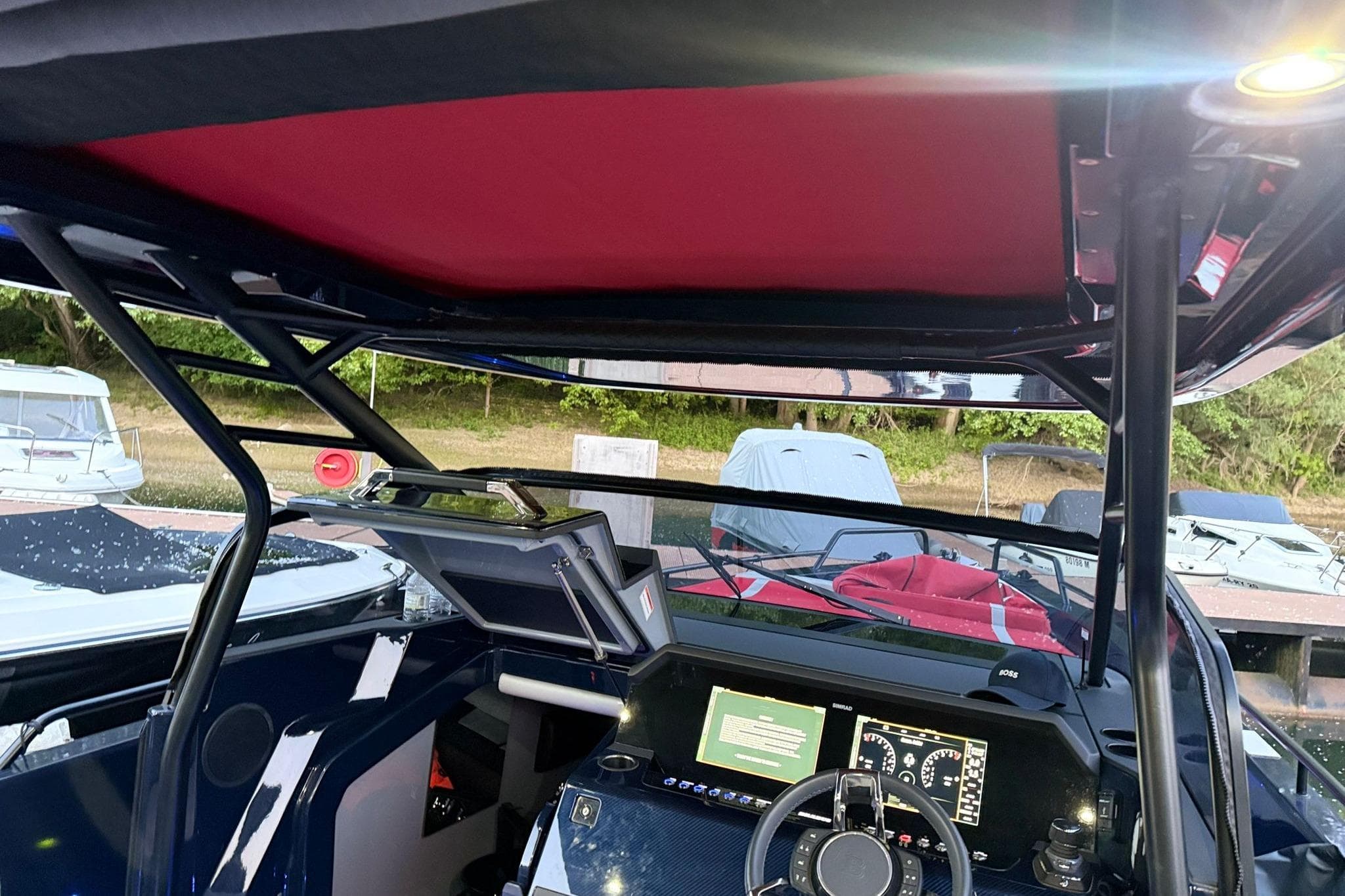 Interior view of 2022 Axopar Brabus Shadow 900 Sun-Top boat cockpit with modern controls.