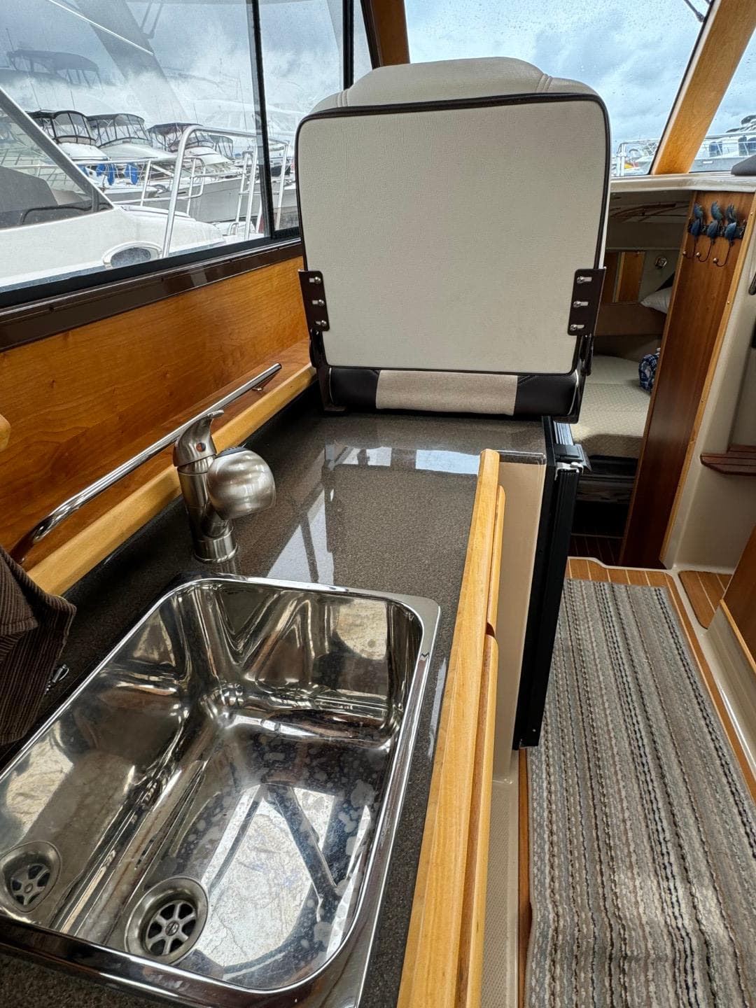 2017 Cutwater C28 interior with sink and seating, showcasing modern design and functionality.