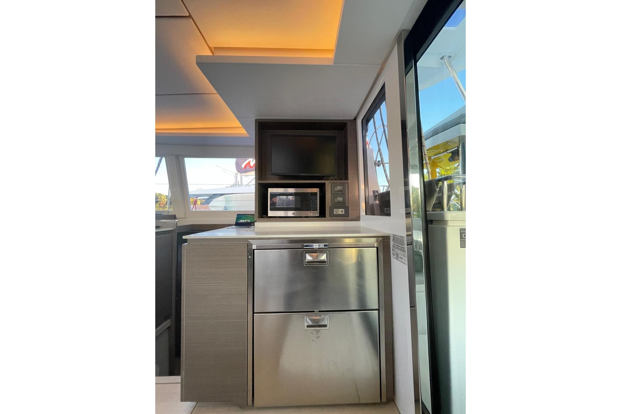 Modern kitchen area on 2022 Leopard 42 yacht with stainless steel appliances.