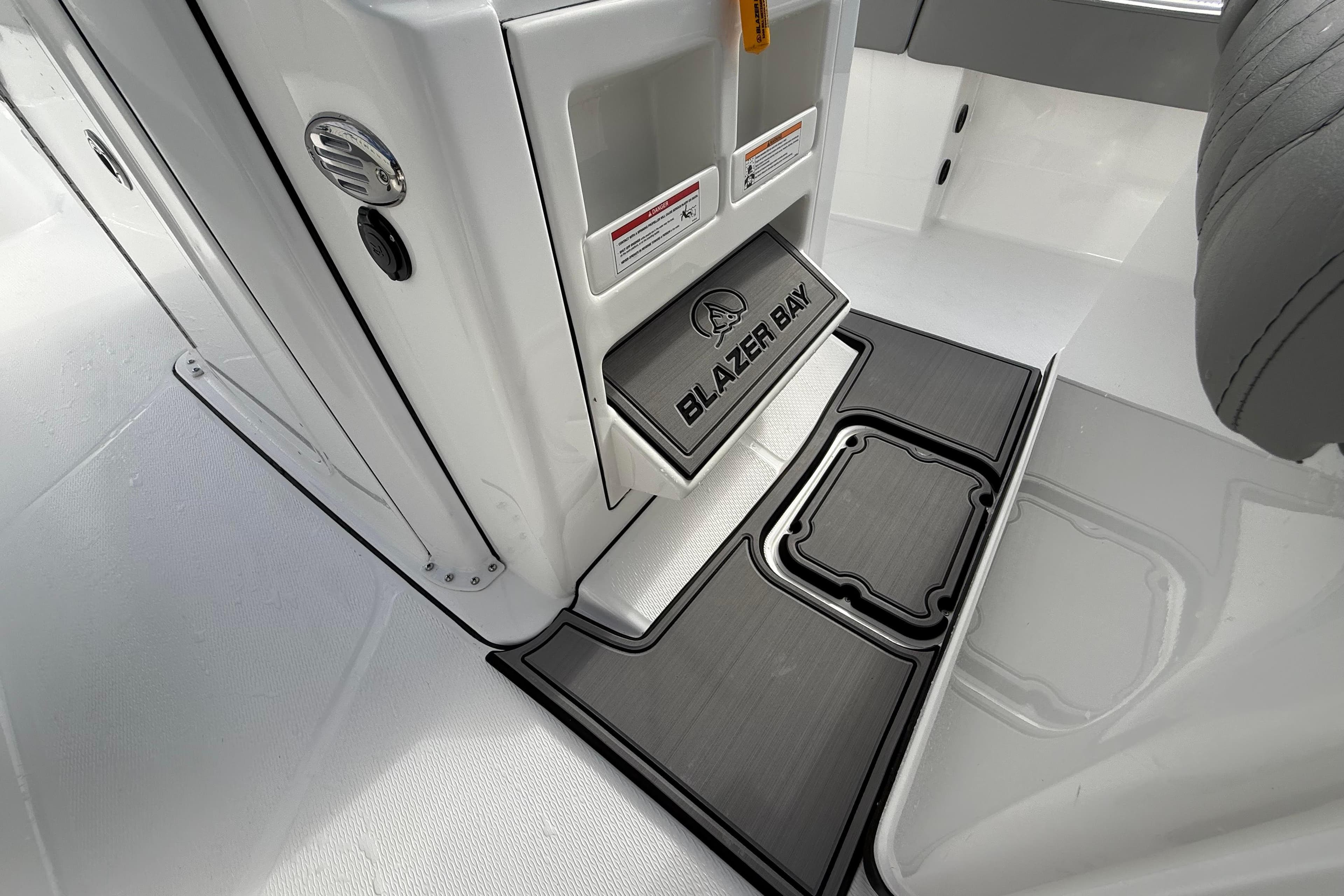 2026 Blazer Bay Makaira 2600 interior detail with branded flooring and storage compartments.
