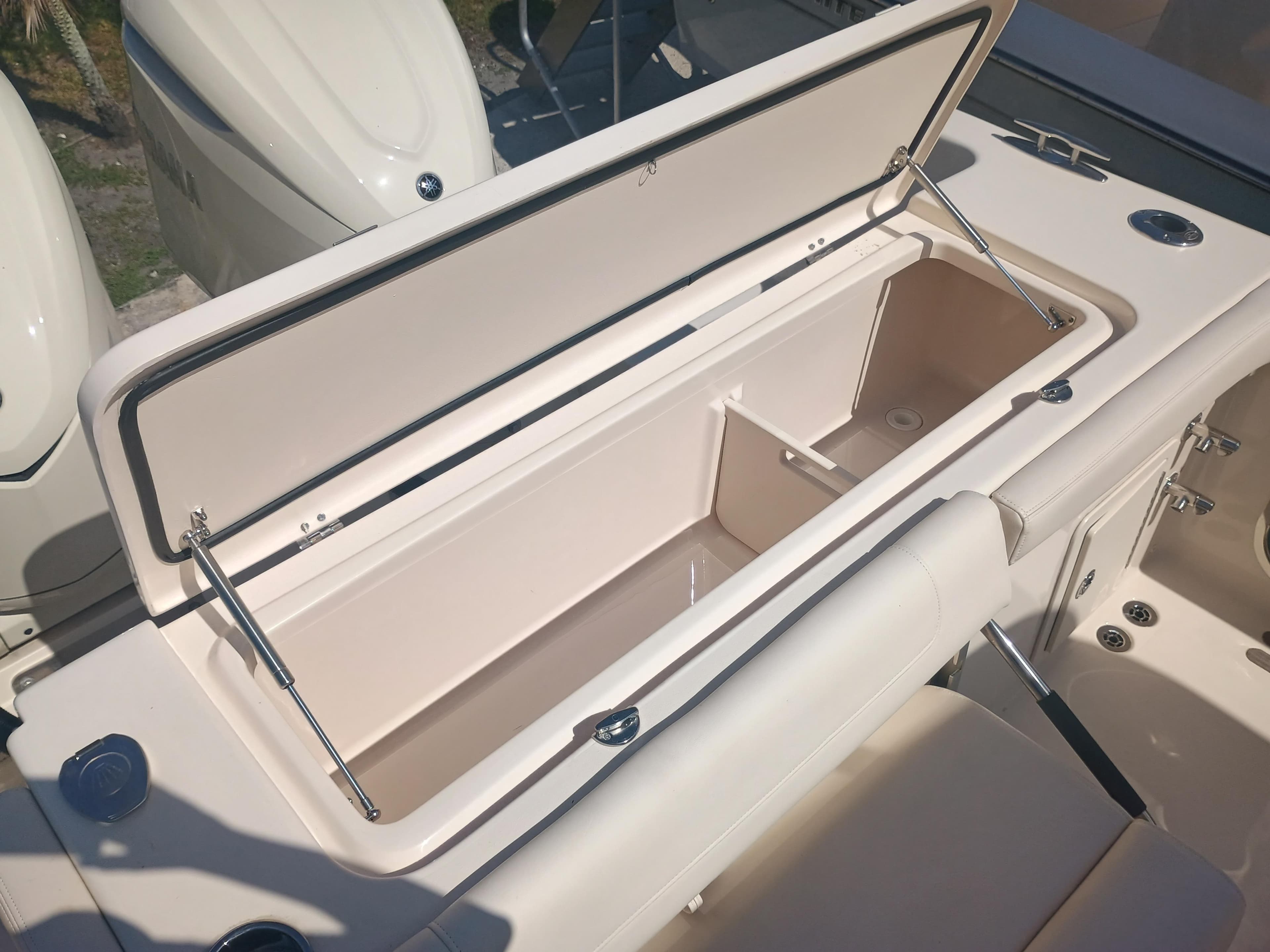 Open storage compartment on 2025 Grady-White Canyon 306 boat, showcasing interior space.