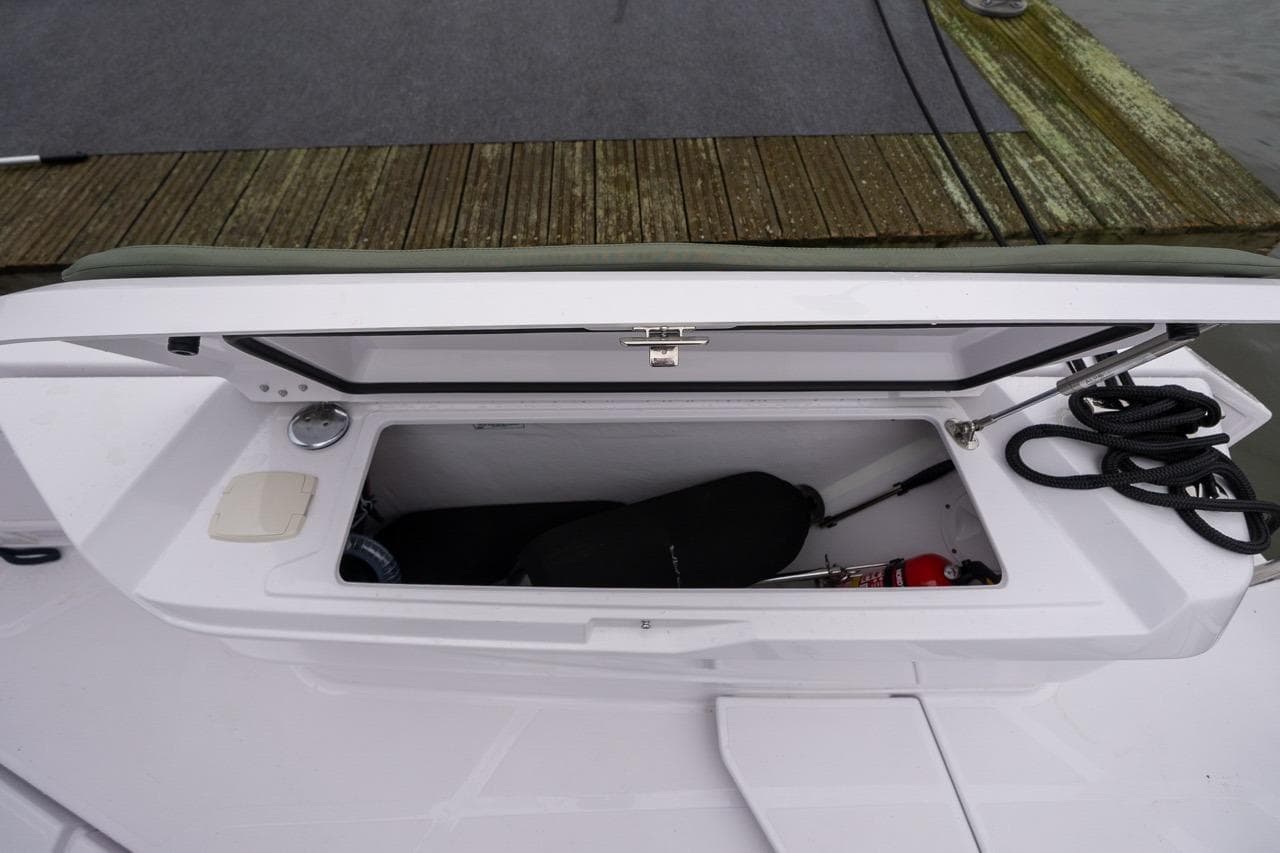 Storage compartment on 2027 Axopar 38 Cross Cabin boat, featuring ropes and equipment.