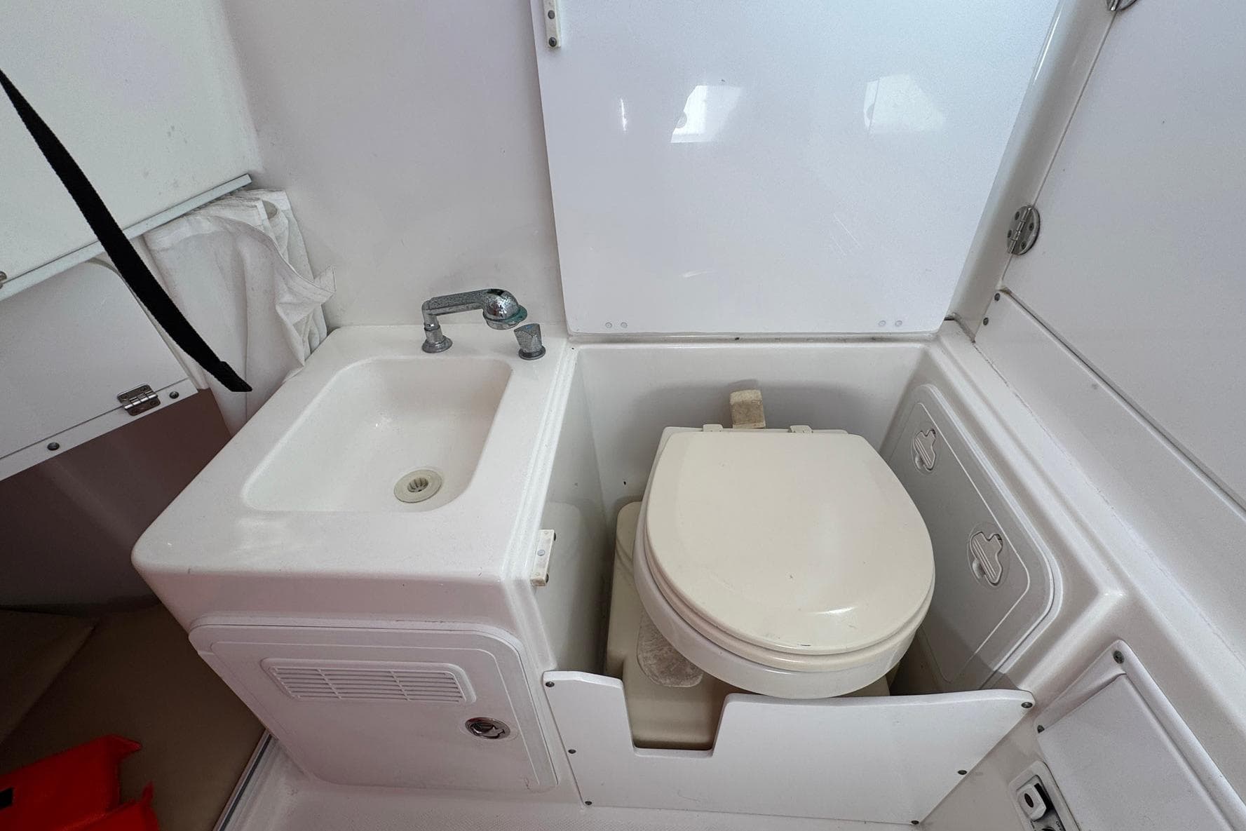 Compact bathroom in 2008 Everglades 350 Center Console boat, featuring sink and toilet.