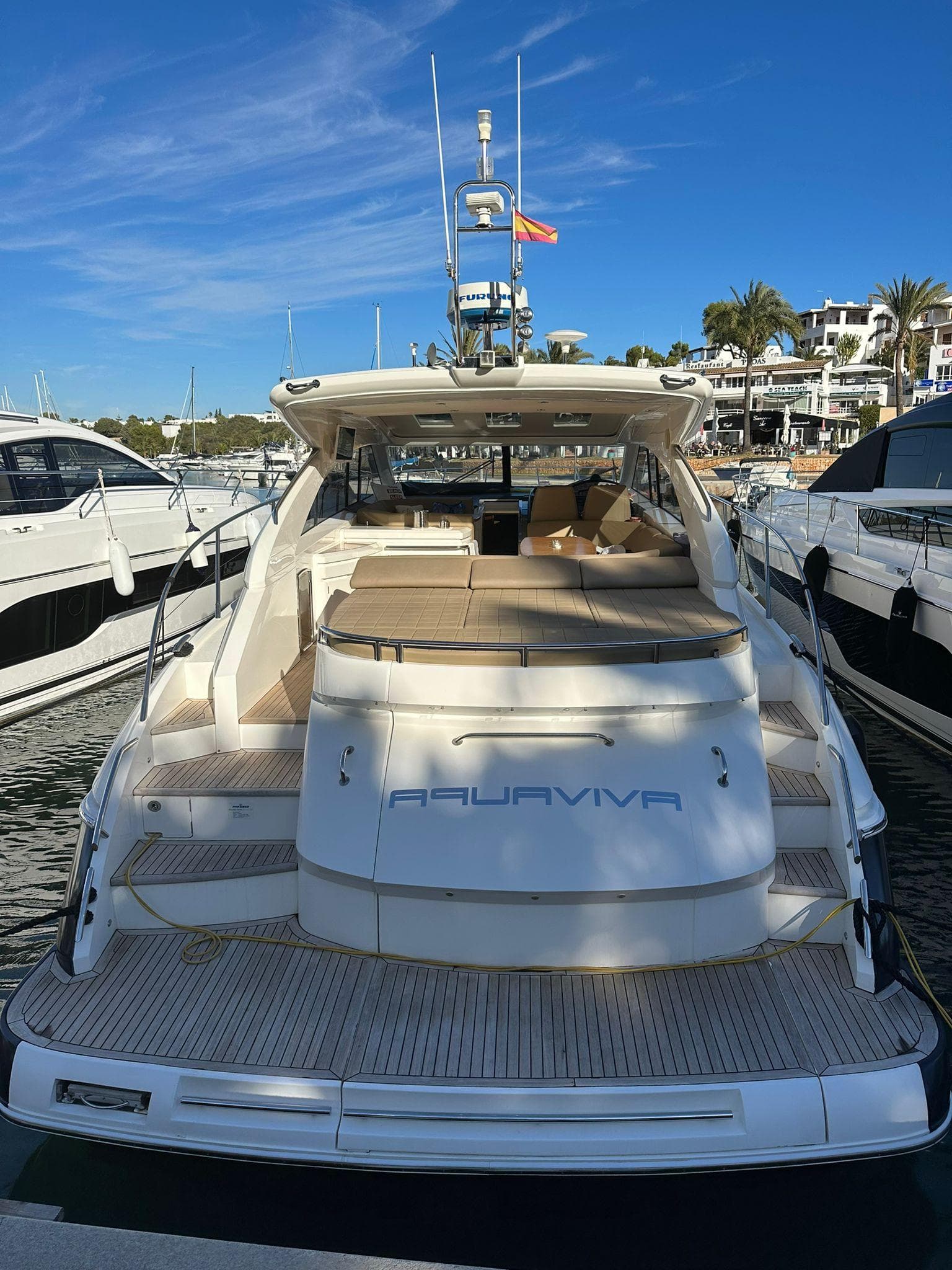 2006 Princess V53 yacht docked at marina, featuring spacious deck and luxurious seating.