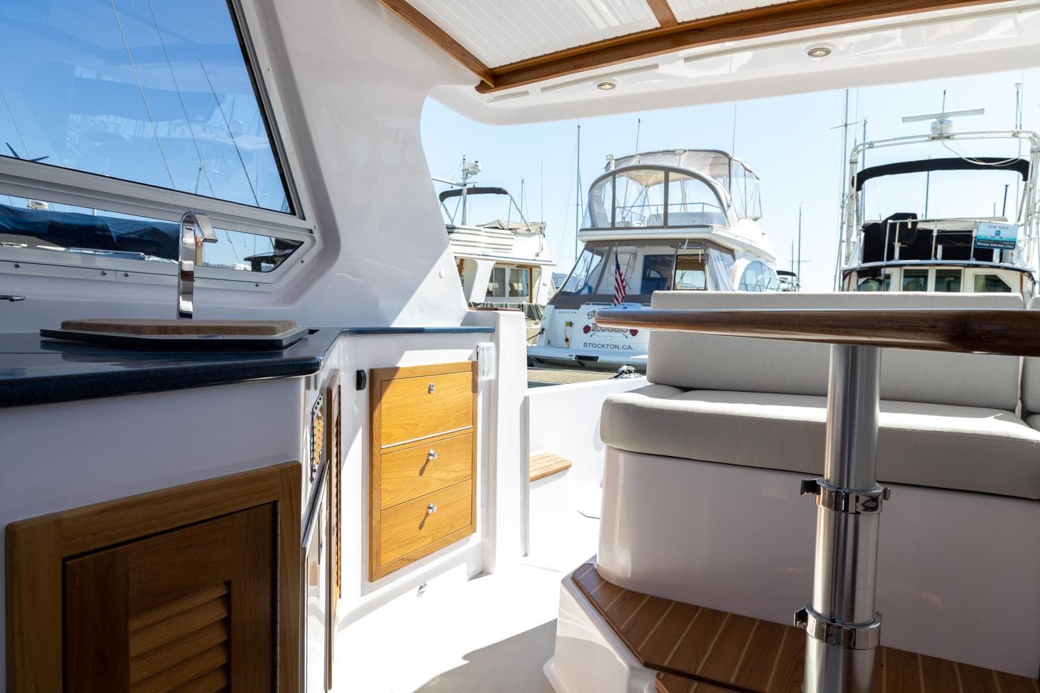 Interior view of 2020 True North 34 yacht with docked boats in background.