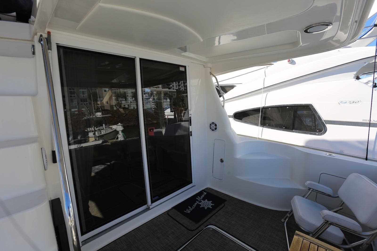 2004 Sea Ray 420 Sedan Bridge yacht deck with sliding glass doors and seating area.