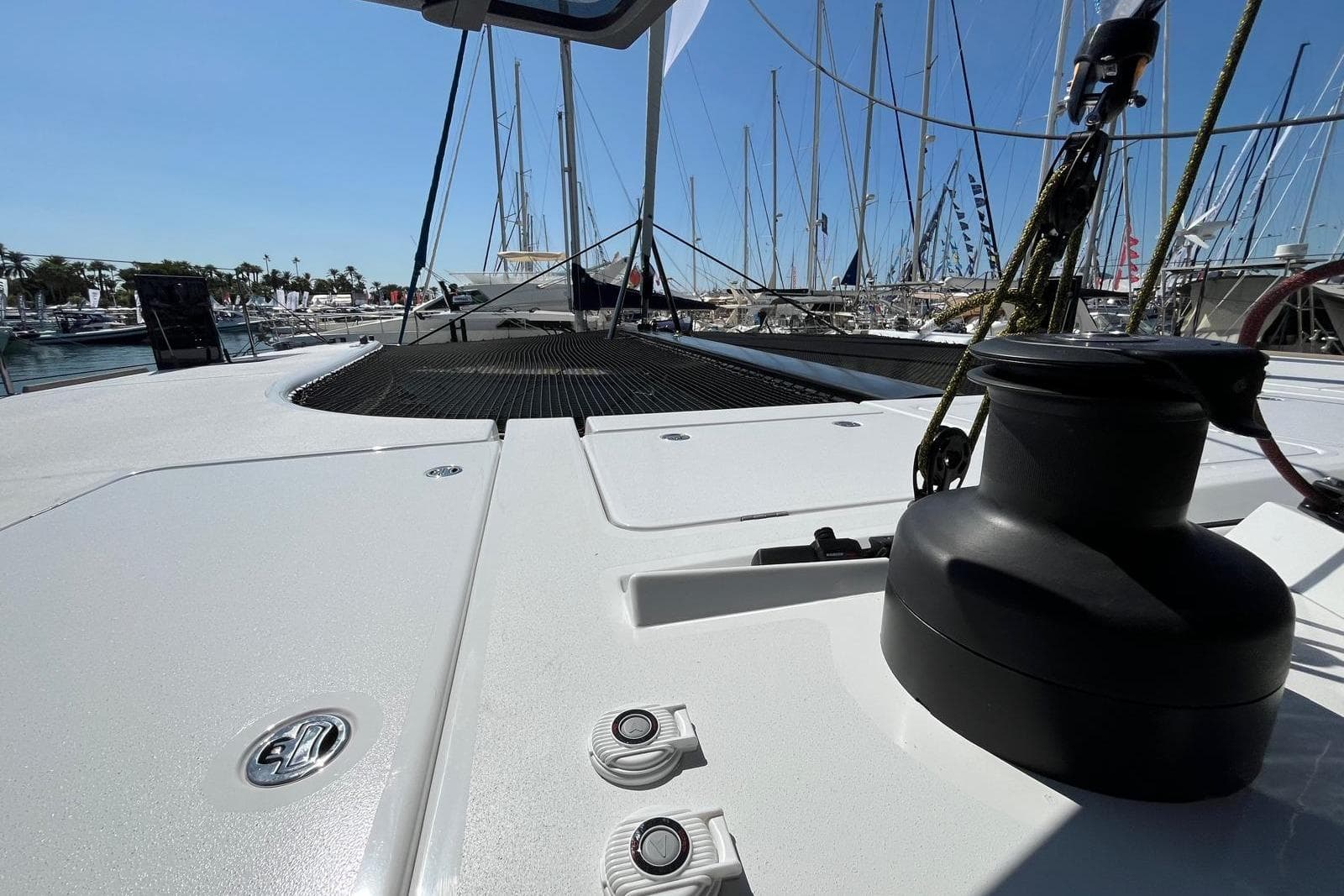 2026 Comar C-CAT 65 catamaran deck view with marina background.