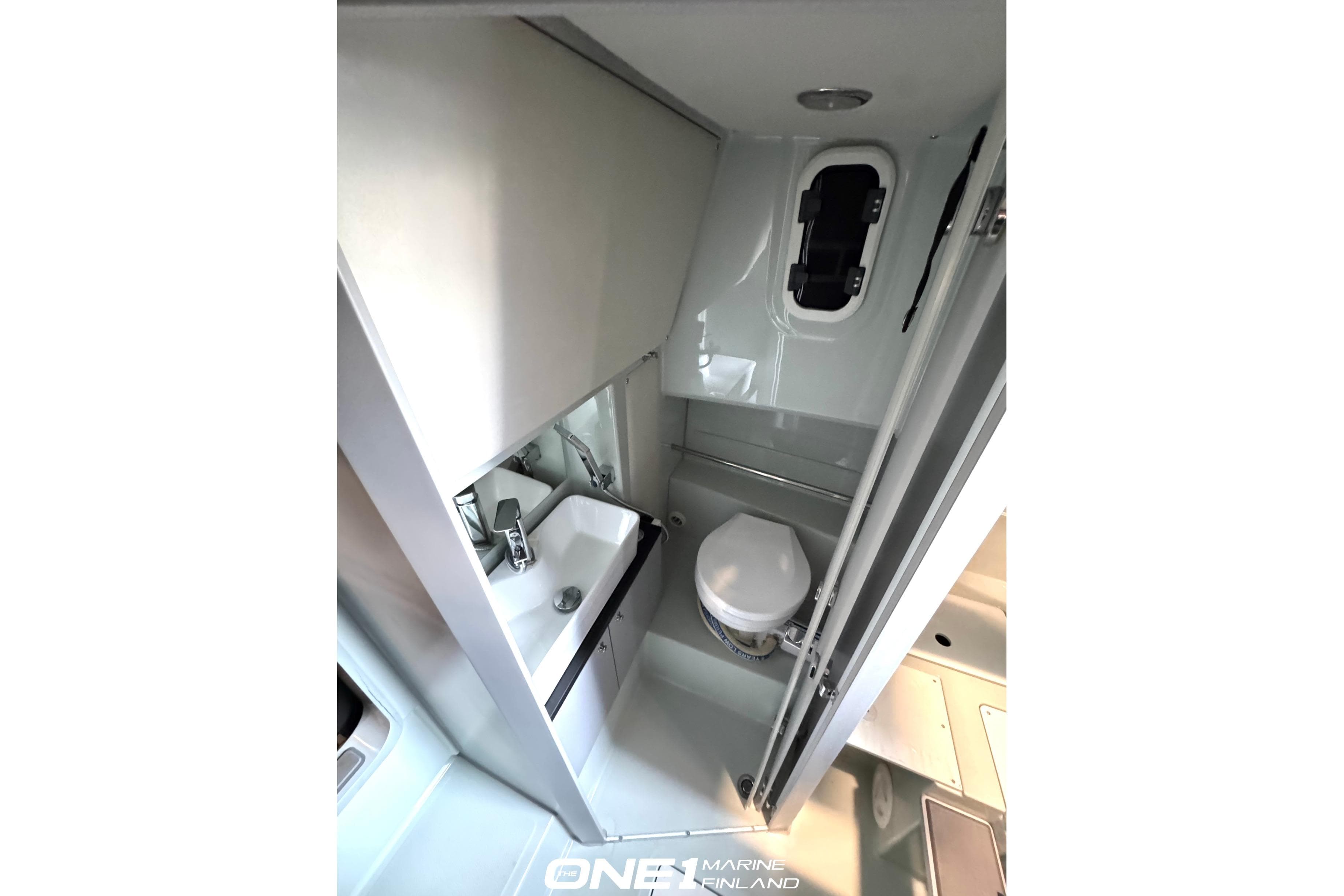 2022 XO DFNDR 9 boat interior bathroom with sink and toilet.