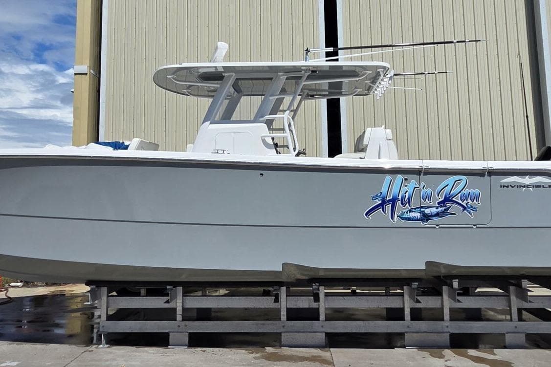 2020 Invincible 35 Catamaran on dock, featuring "Hit'n Run" graphic.