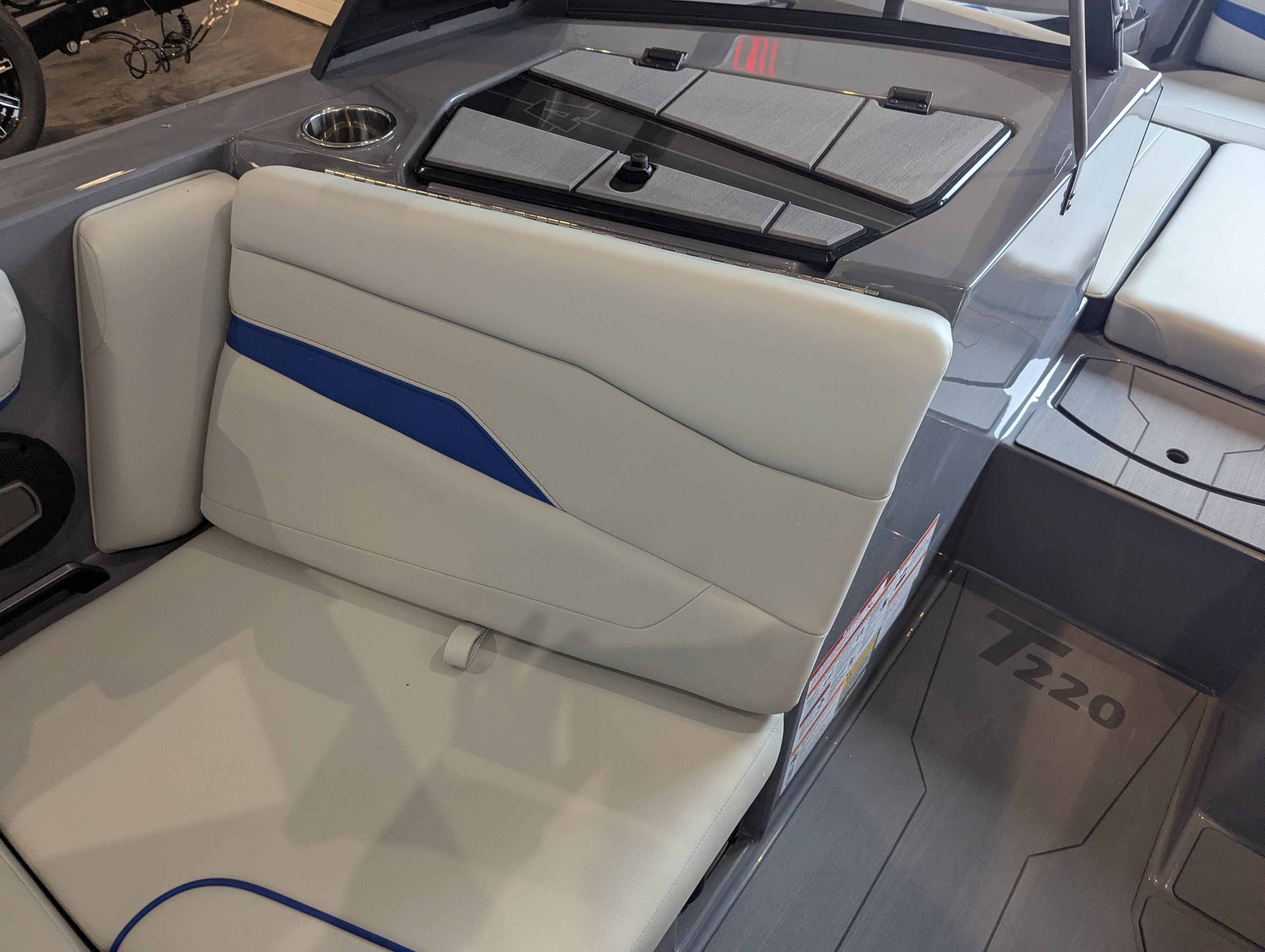 Interior of 2025 Axis T220 boat with white and blue seating.