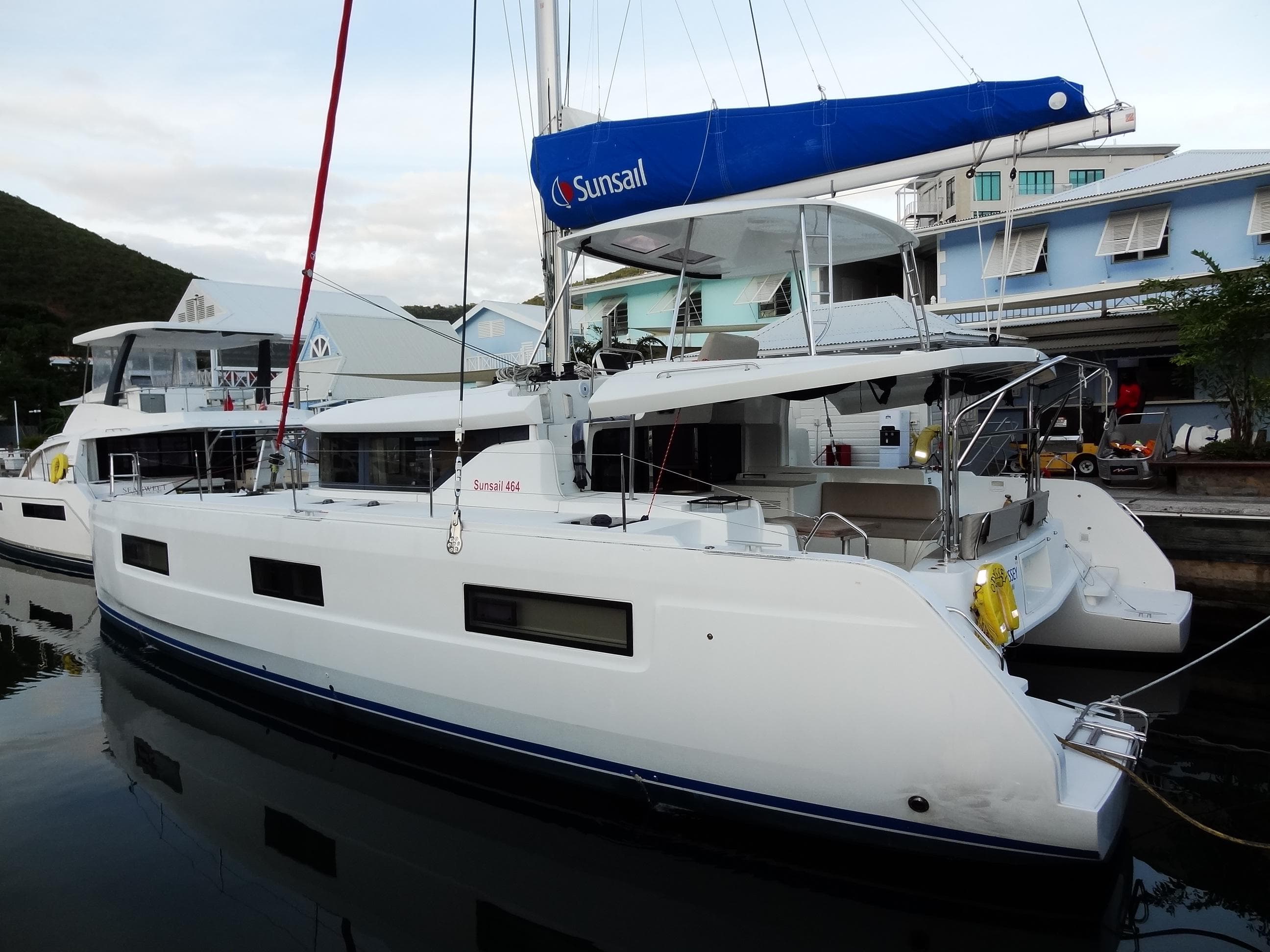 2020 Lagoon 46 catamaran docked, featuring sleek design and spacious deck.