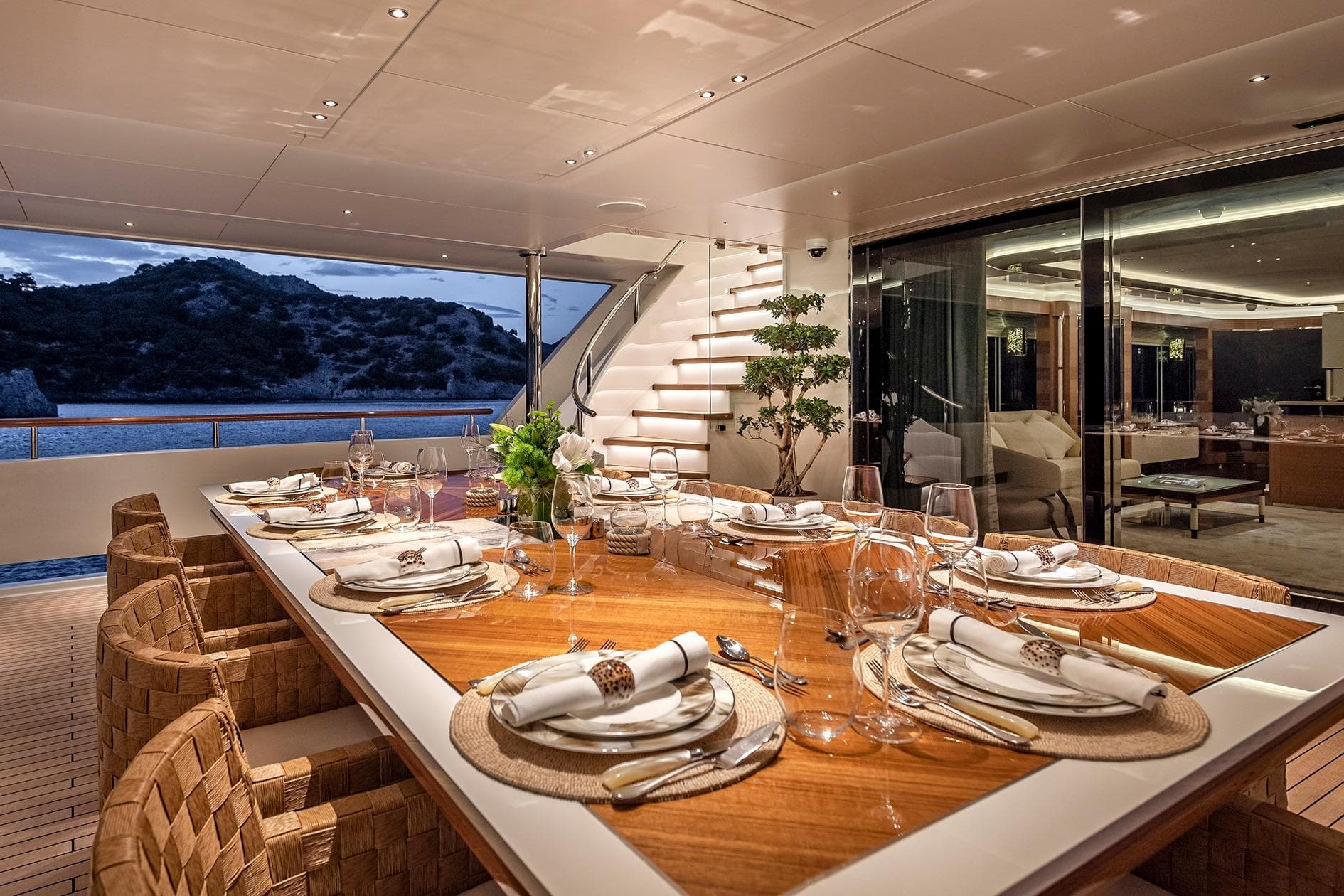 Luxurious dining area on 2019 Yildiz 141 yacht, elegantly set table with ocean view.