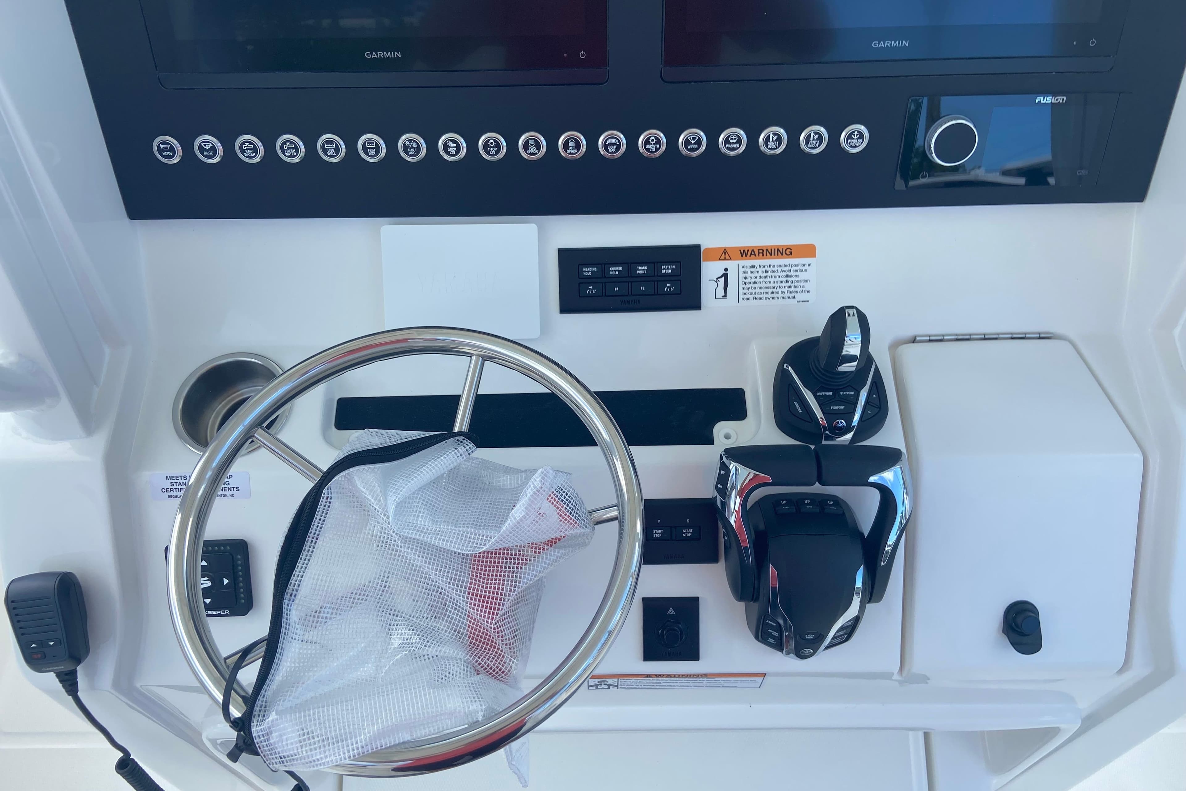 2026 Regulator 28 boat dashboard with steering wheel and control panel.