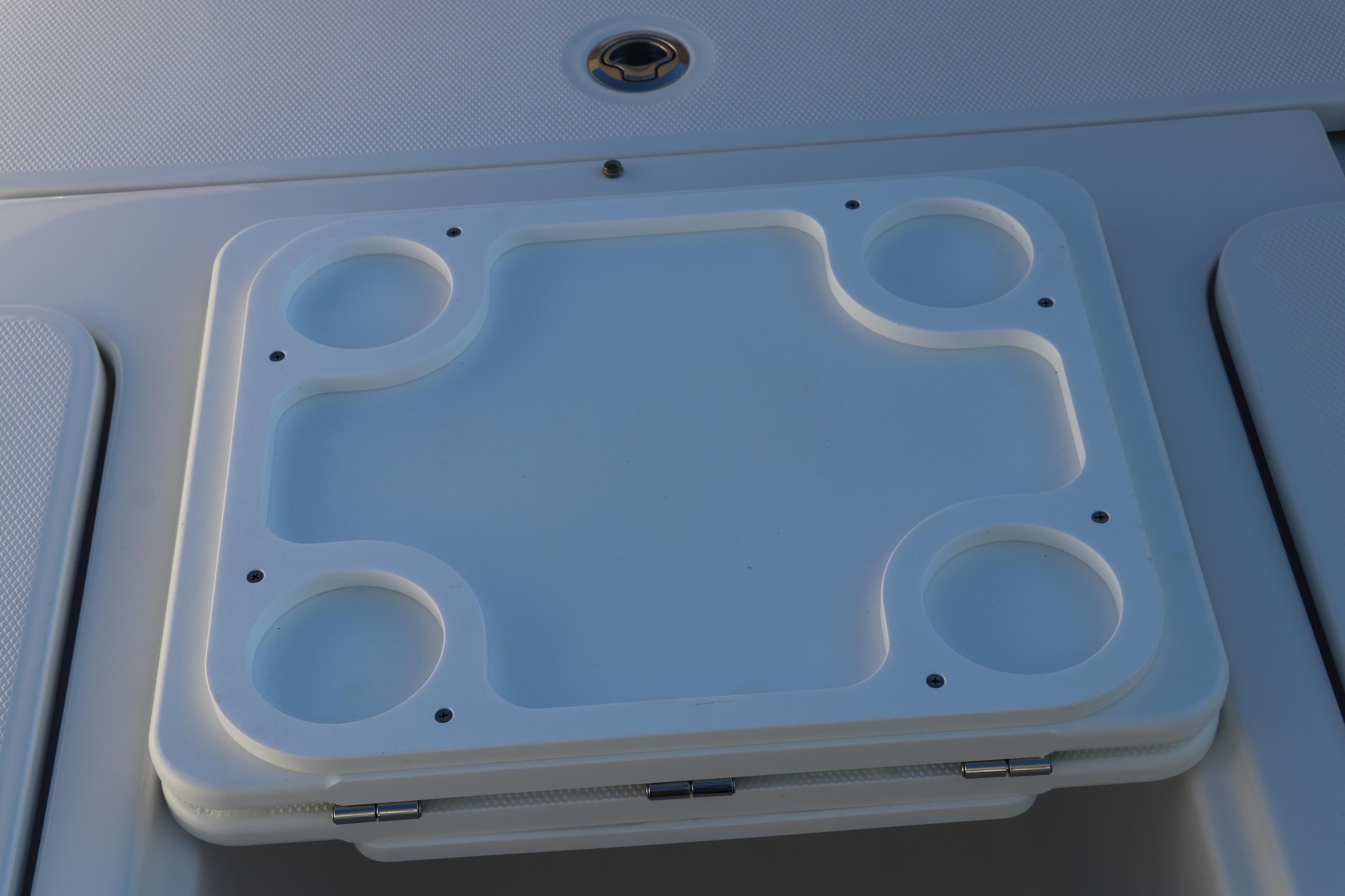 Edgewater 248 CX 2025 boat cup holder and storage compartment lid.