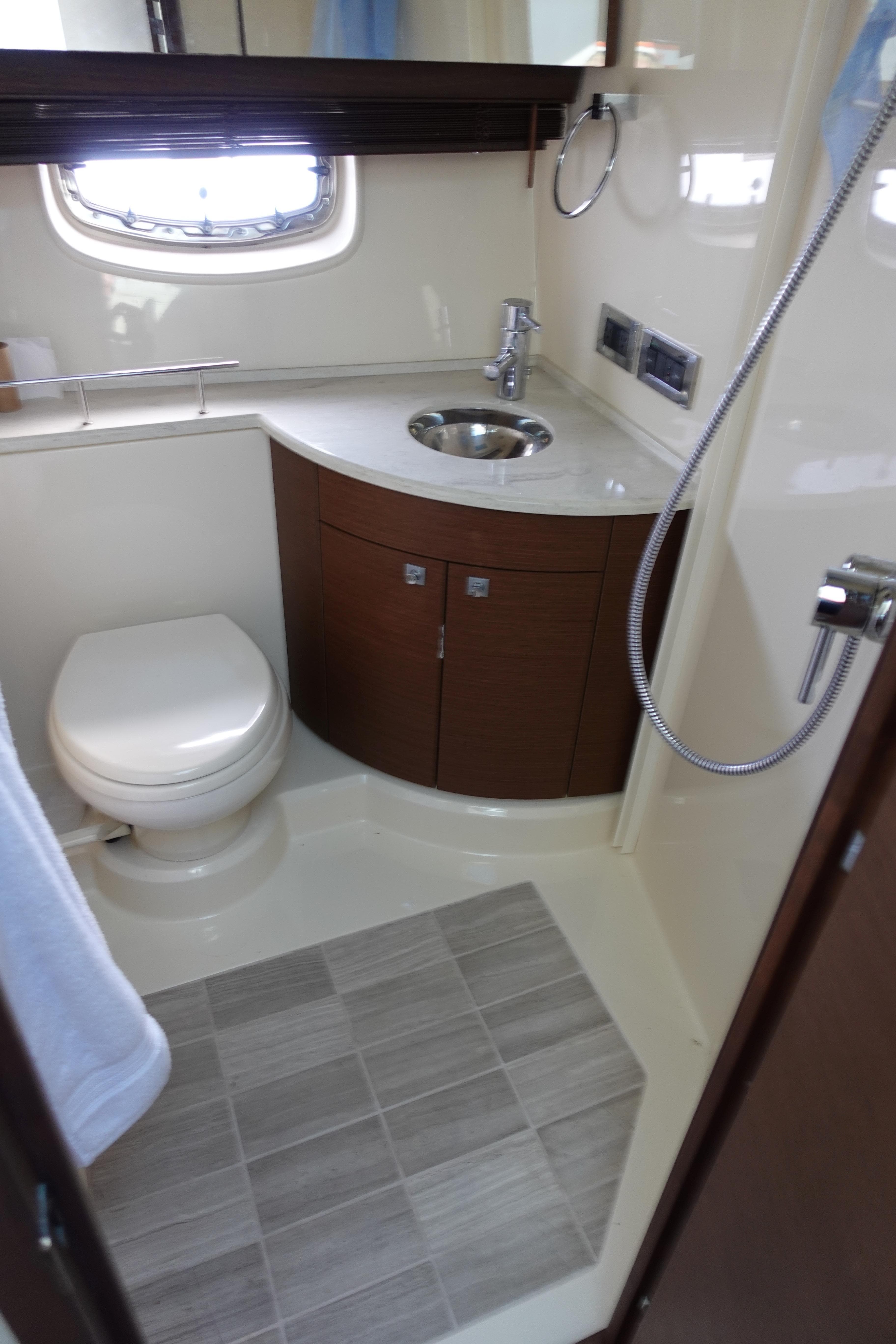 2012 Sea Ray 450 Sedan Bridge bathroom with modern fixtures and compact design.