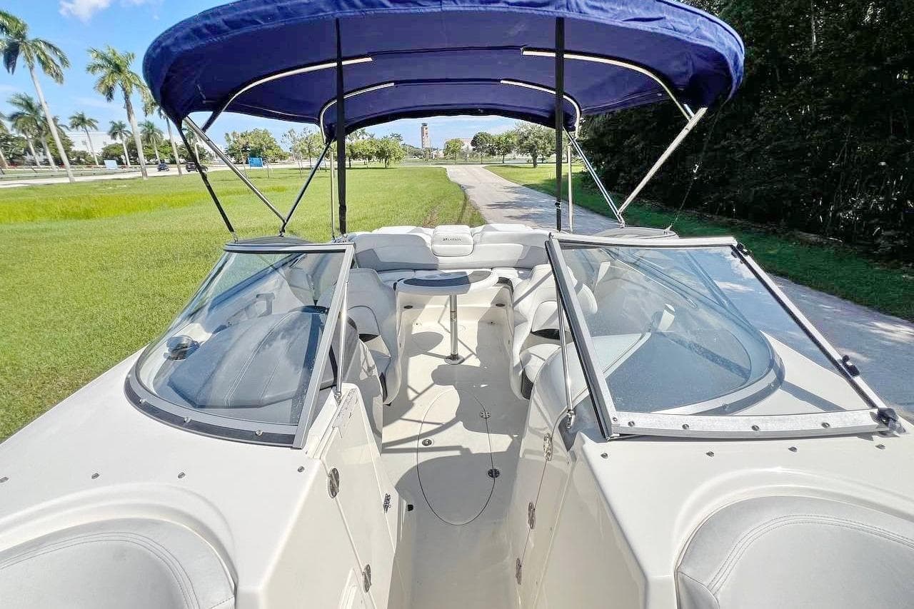 2013 Larson LXi 292 IO boat with blue canopy and spacious seating.