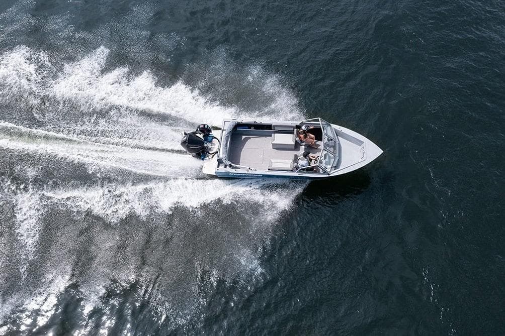 Aerial view of 2026 KingFisher 2025 Escape boat speeding on water.