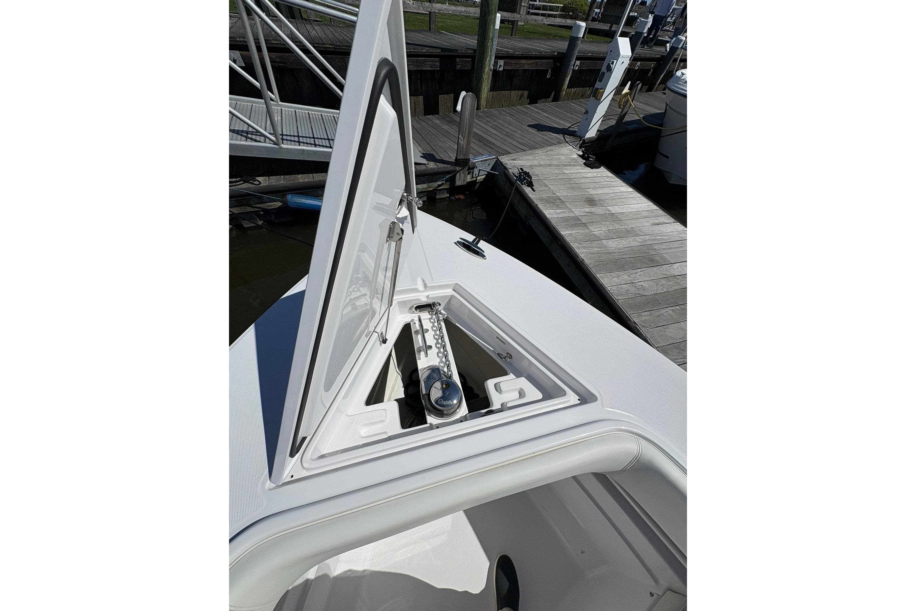 Open anchor compartment on 2023 Jupiter 30 boat at dockside.
