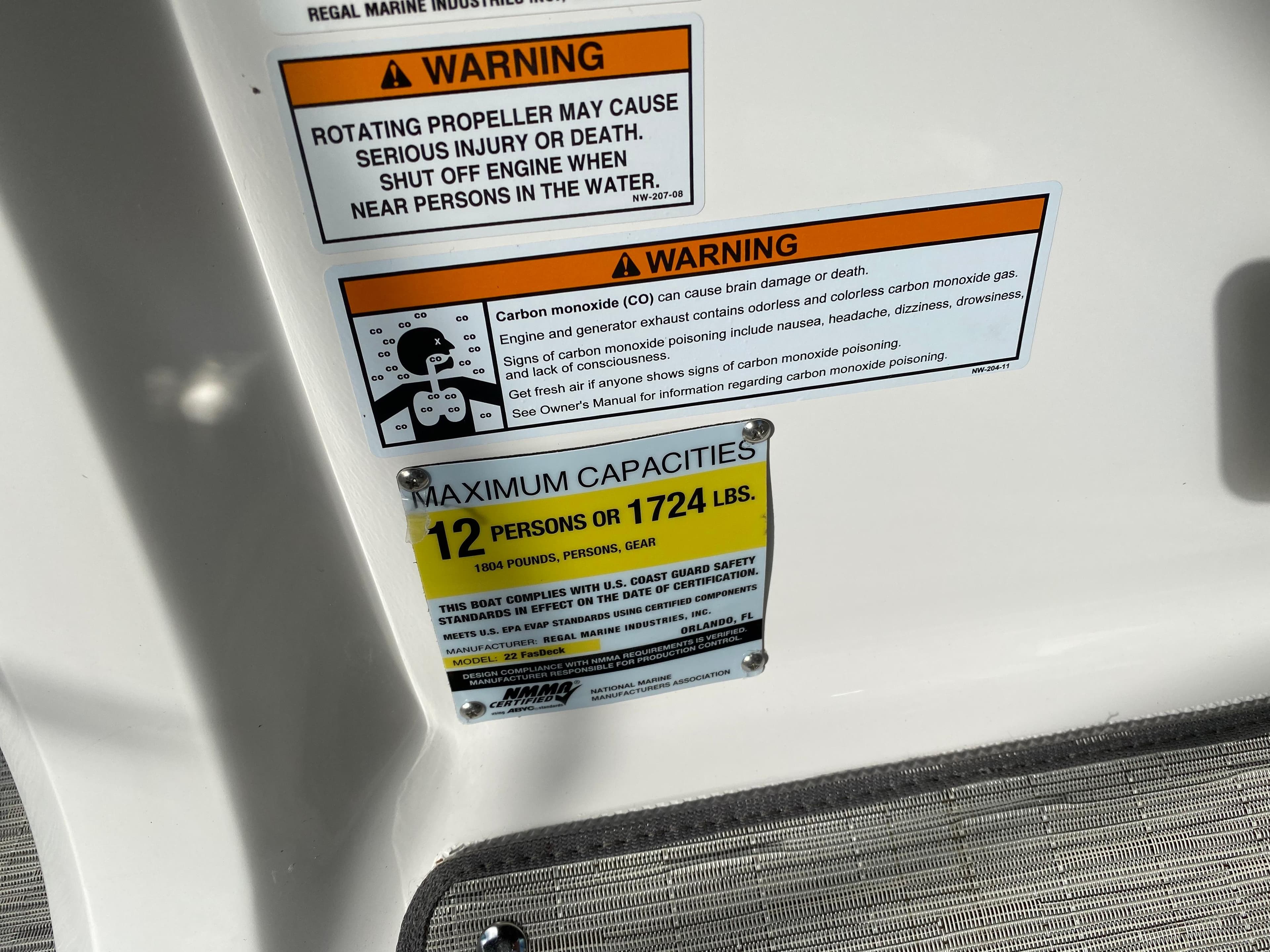 Warning labels and capacity limits on a 2017 Regal 22 FasDeck boat.